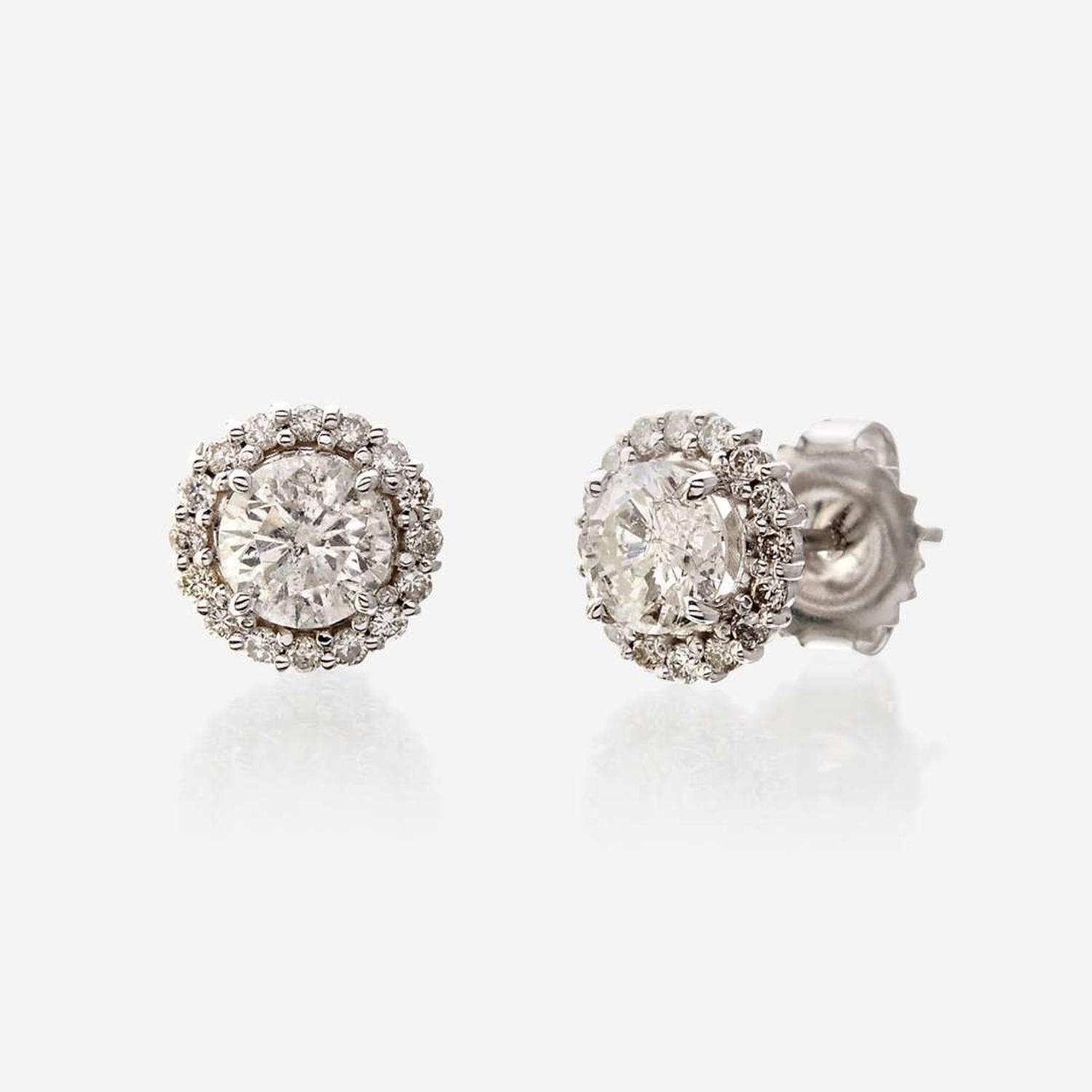 A pair of diamond and eighteen karat white gold earrings