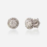 A pair of diamond and eighteen karat white gold earrings