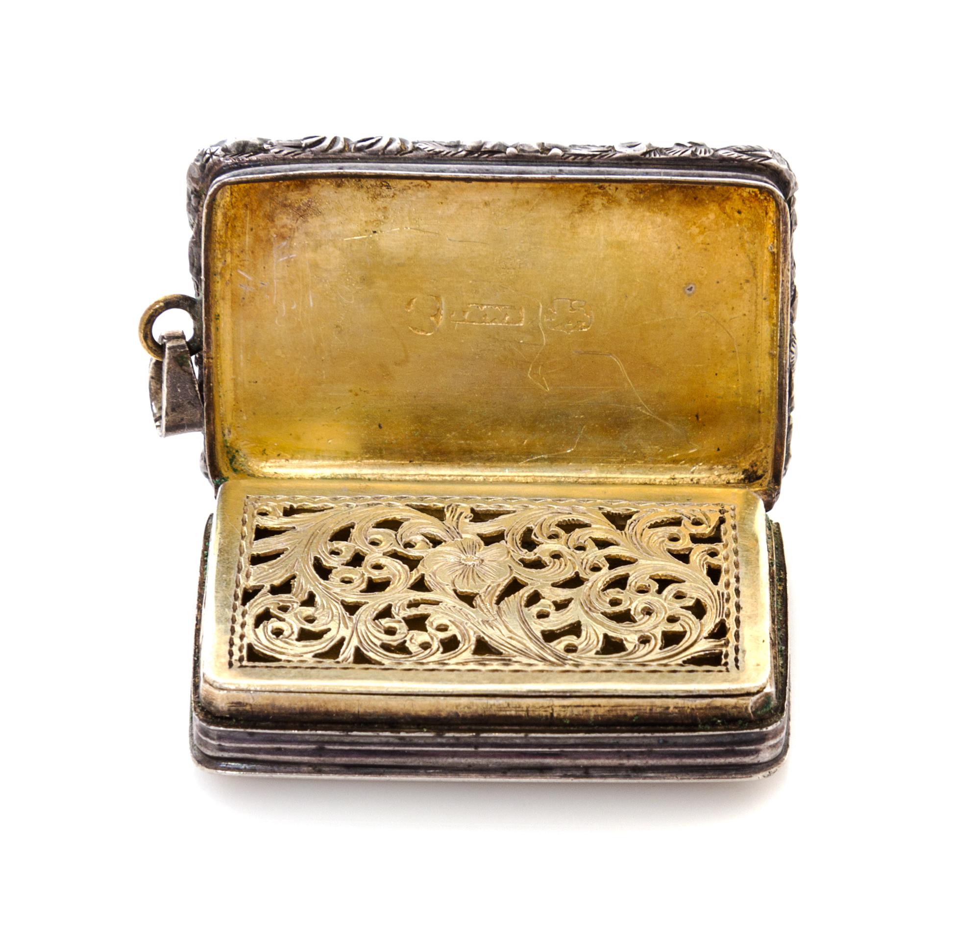 A George IV Silver Vinaigrette, Maker's mark T&WS, Birmingham, 1822, having a floral and foliate decorated border centered by a cartouc