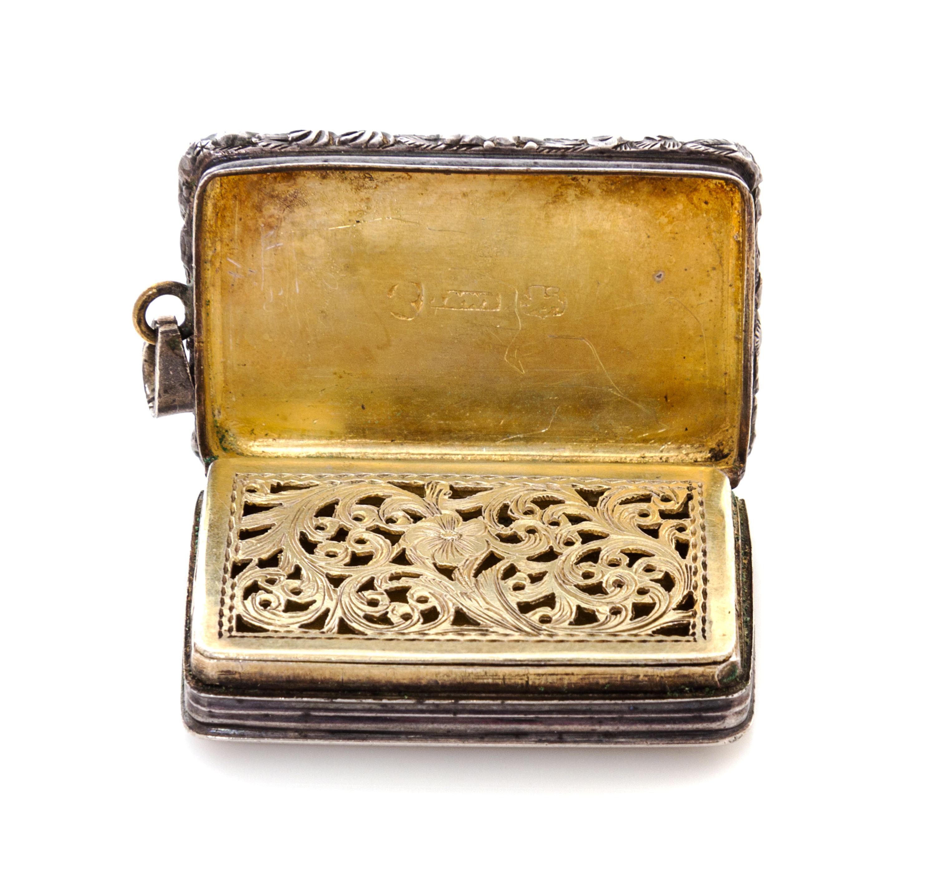 A George IV Silver Vinaigrette, Maker's mark T&WS, Birmingham, 1822, having a floral and foliate decorated border centered by a cartouc