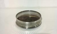 An Elizabeth II Silver Wine Coaster, Goldsmiths & Silversmiths Ltd., London, 1977, with pierced sides.