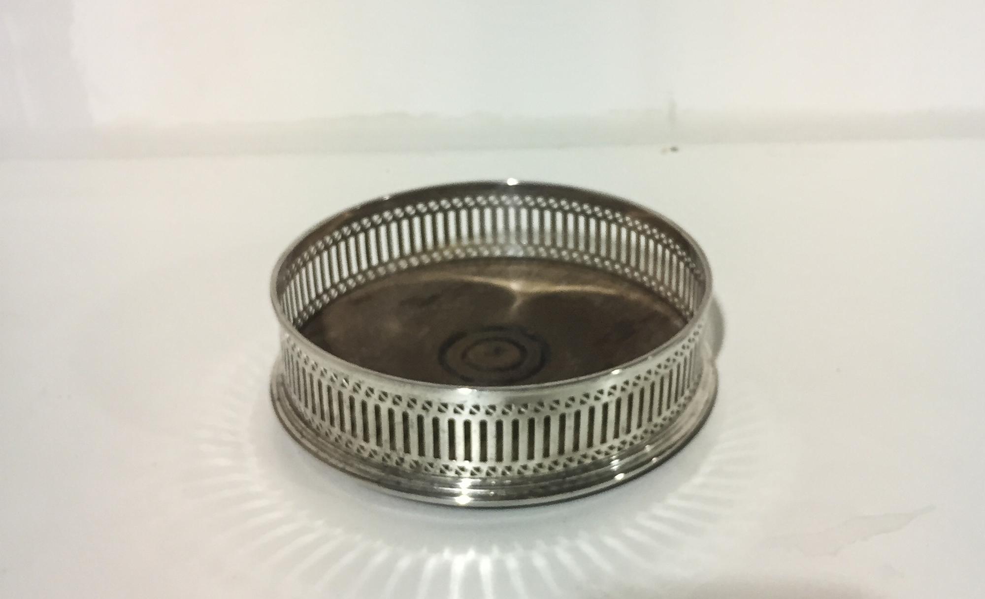 An Elizabeth II Silver Wine Coaster, Goldsmiths & Silversmiths Ltd., London, 1977, with pierced sides.