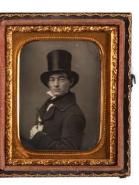 [EARLY PHOTOGRAPHY]. Ninth plate daguerreotype portrait of a man wearing a top hat and holding a revolver to his chest. New York: Holmes, n.d.