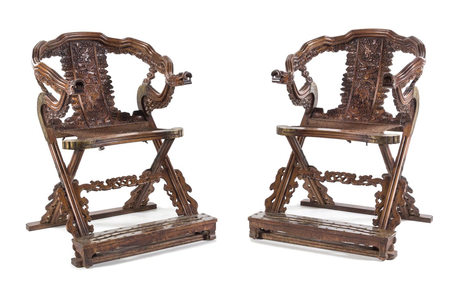 A Pair of Chinese Carved and Brass Mounted Folding Armchairs Height 42 3/4 x width 31 3/4 x depth 31 inches.