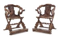 A Pair of Chinese Carved and Brass Mounted Folding Armchairs Height 42 3/4 x width 31 3/4 x depth 31 inches.