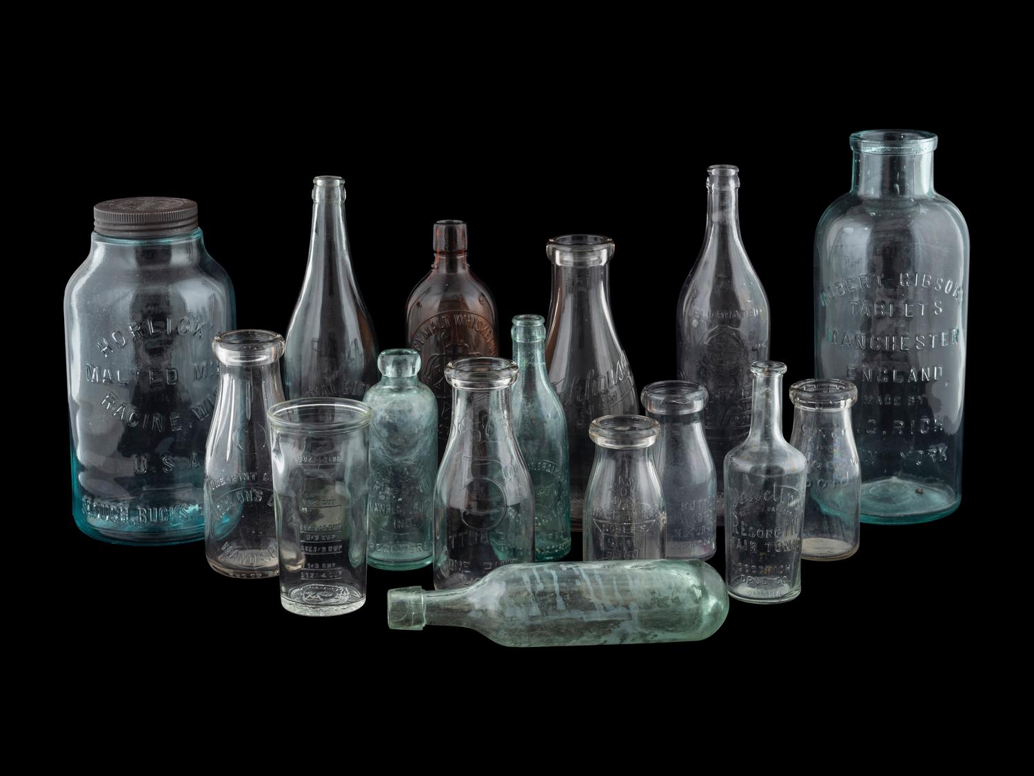 Sixteen Glass Advertising Bottles