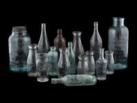 Sixteen Glass Advertising Bottles