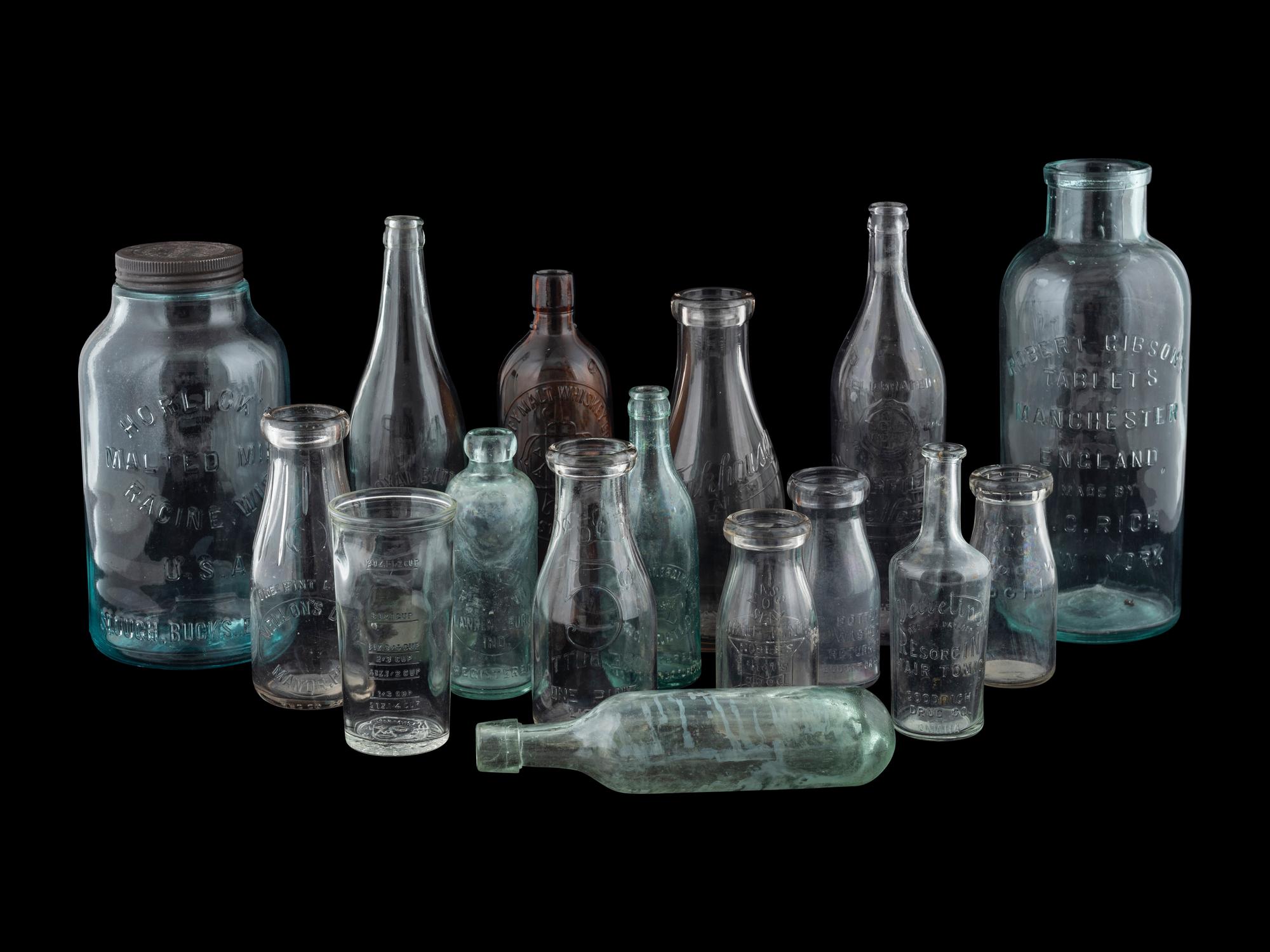 Sixteen Glass Advertising Bottles