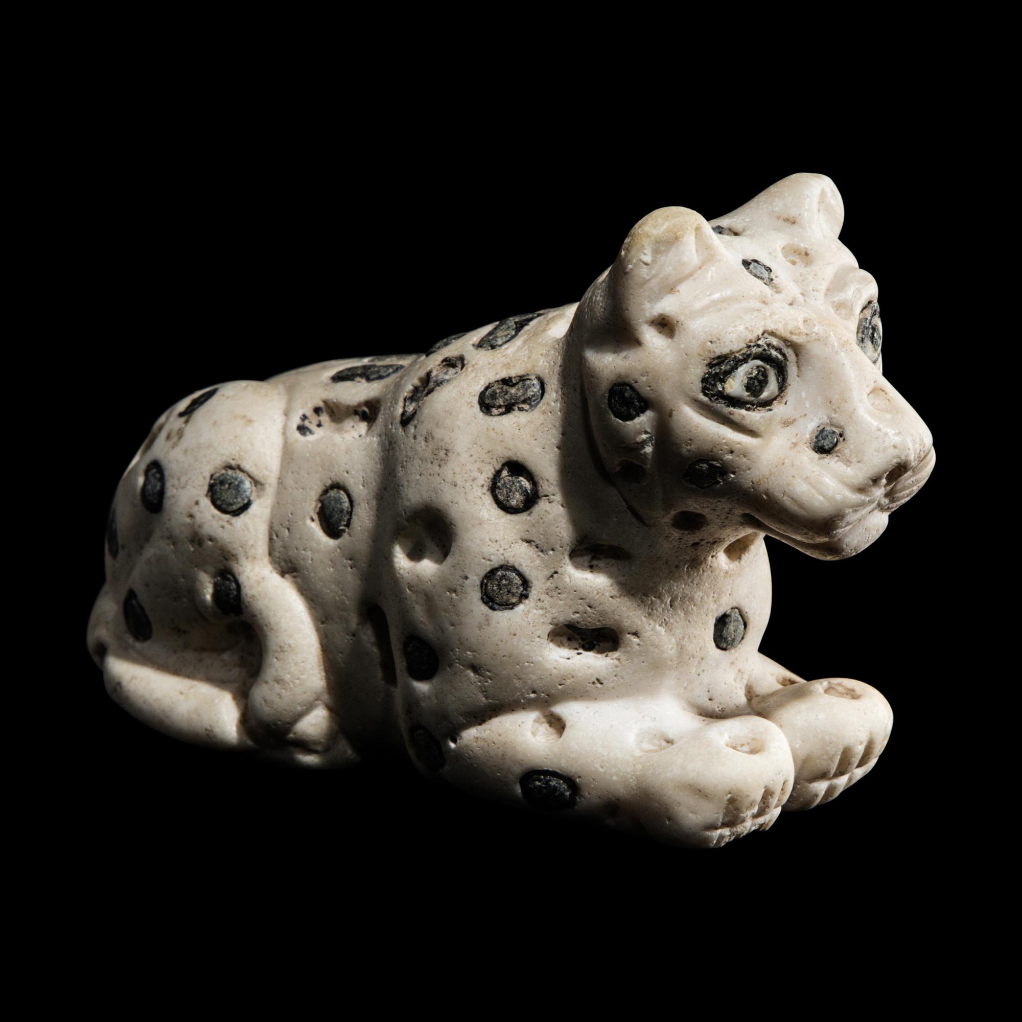 A Mesopotamian Marble and Lapis Lazuli Recumbent Leopard