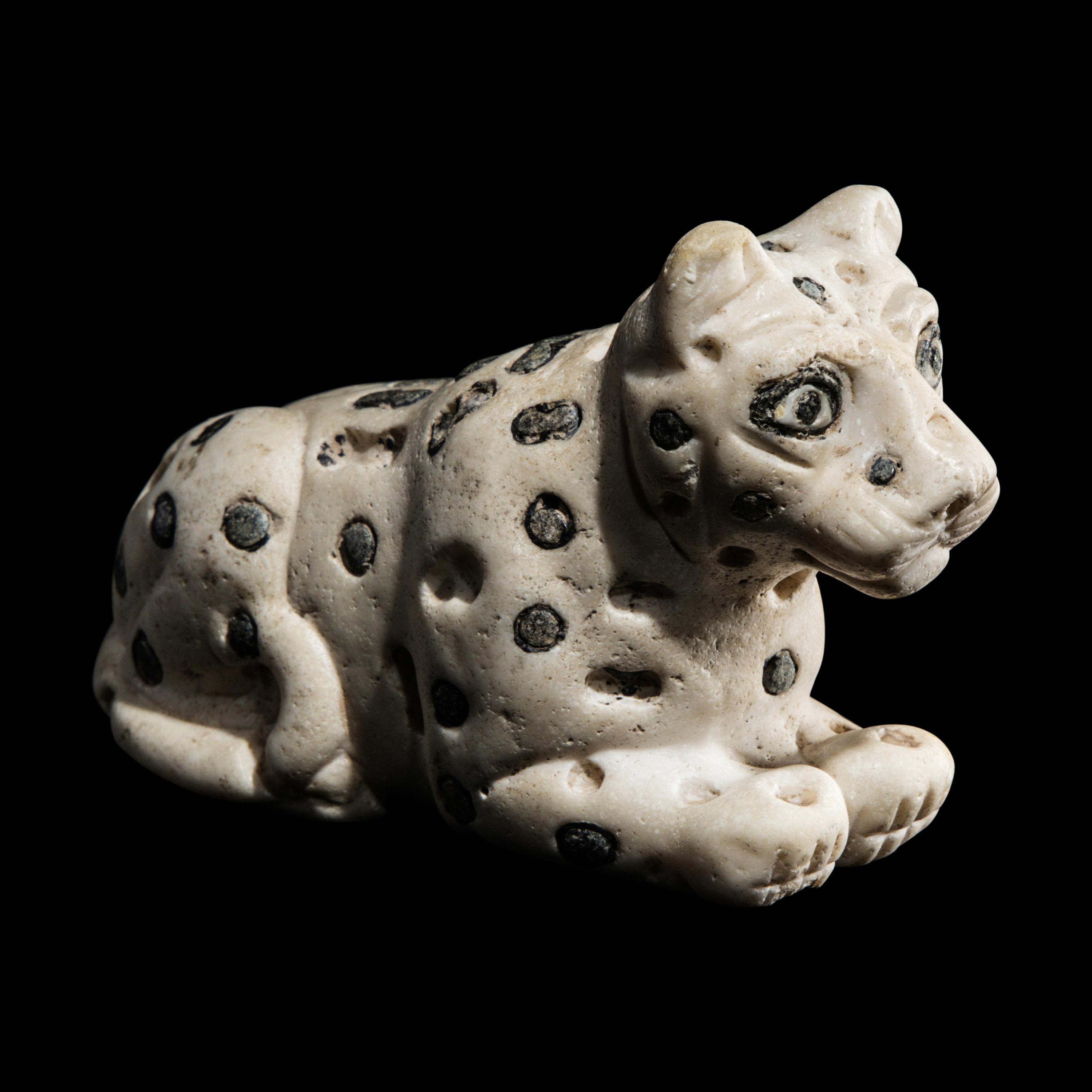A Mesopotamian Marble and Lapis Lazuli Recumbent Leopard