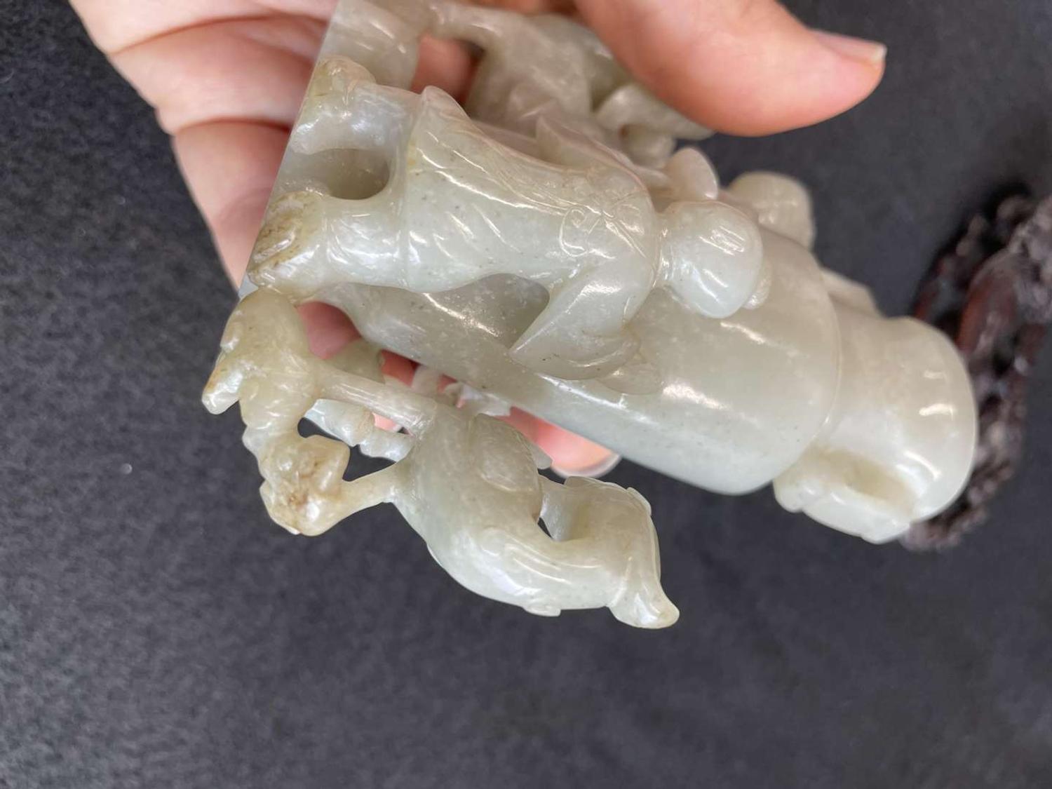 A Chinese jade "Boys, Kylin and Phoenix" vase on carved wood stand 玉雕童子凤鸟花樽及底座
