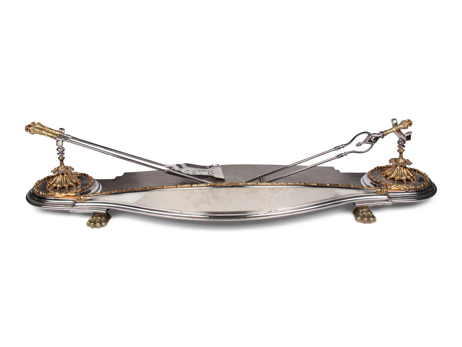 A Steel and Brass Fireplace Fender and Three Tools