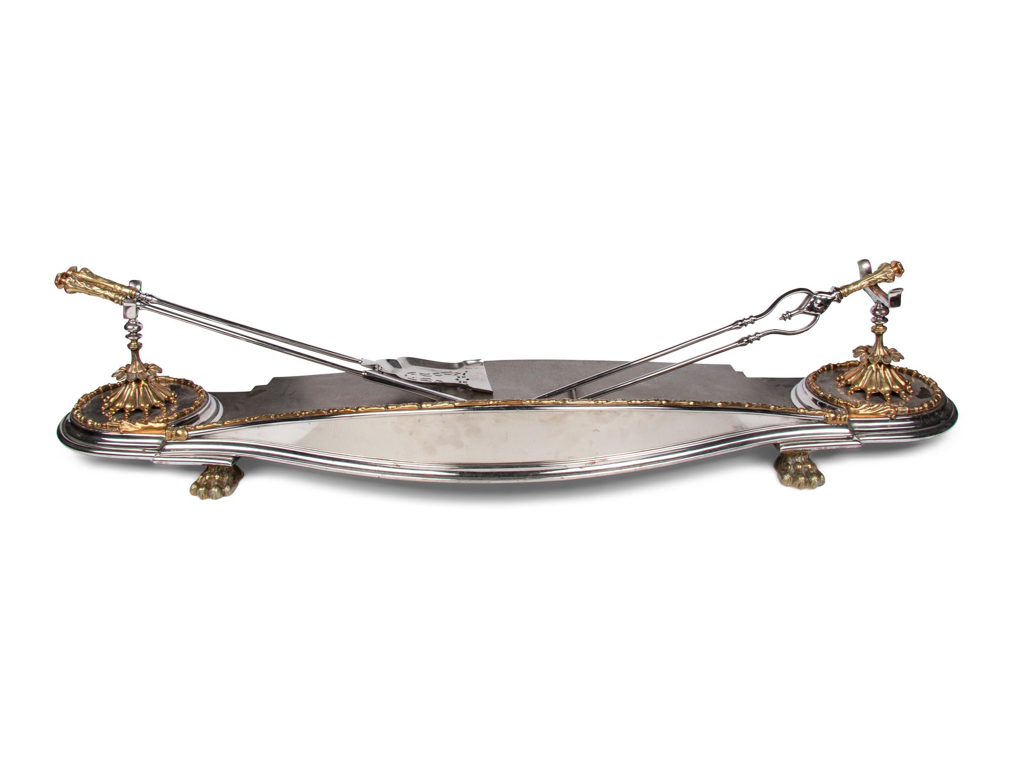 A Steel and Brass Fireplace Fender and Three Tools