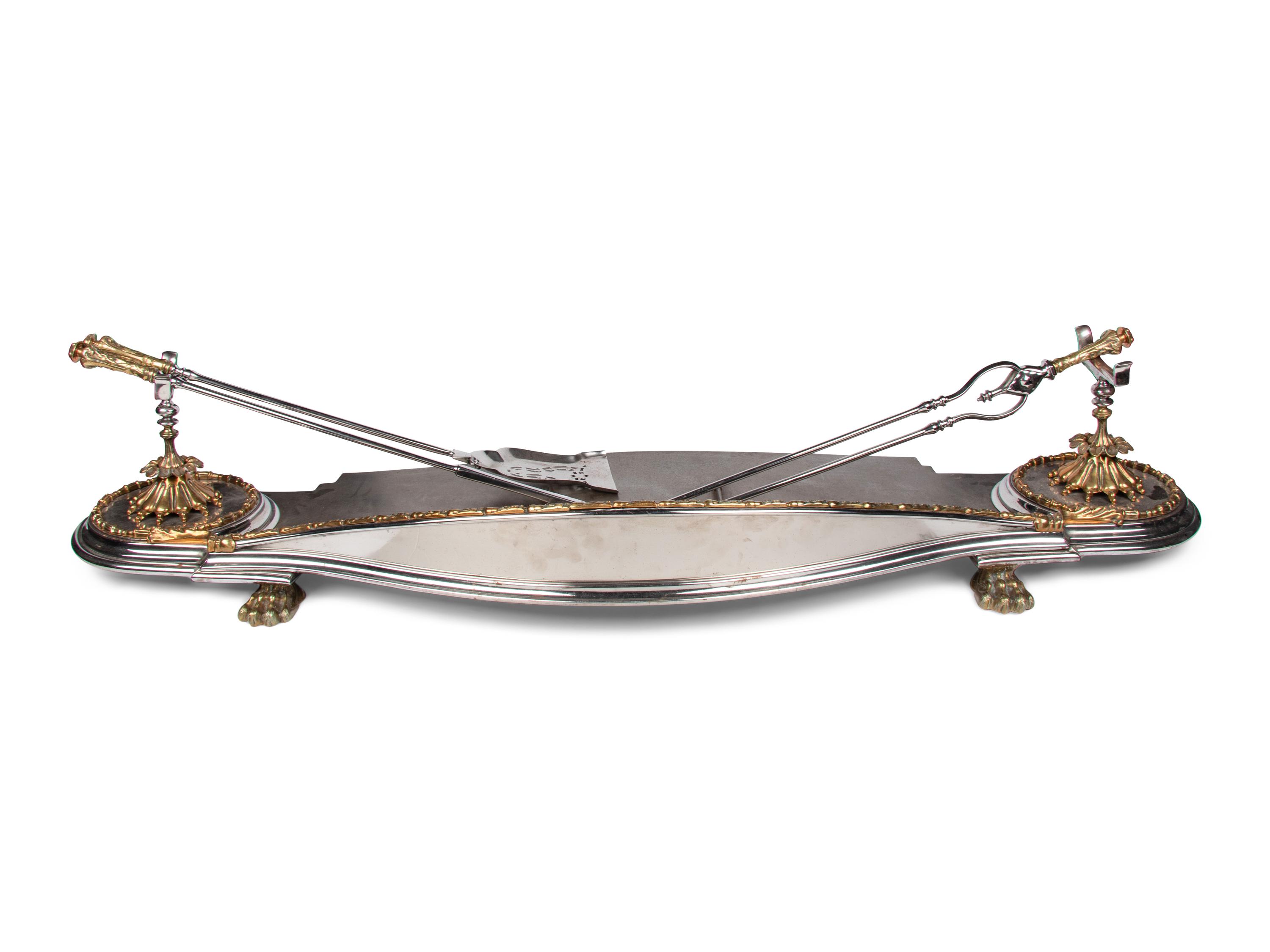 A Steel and Brass Fireplace Fender and Three Tools