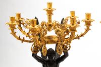 A Pair of Monumental Empire Style Gilt and Patinated Metal Seven-Light Figural Candelabra