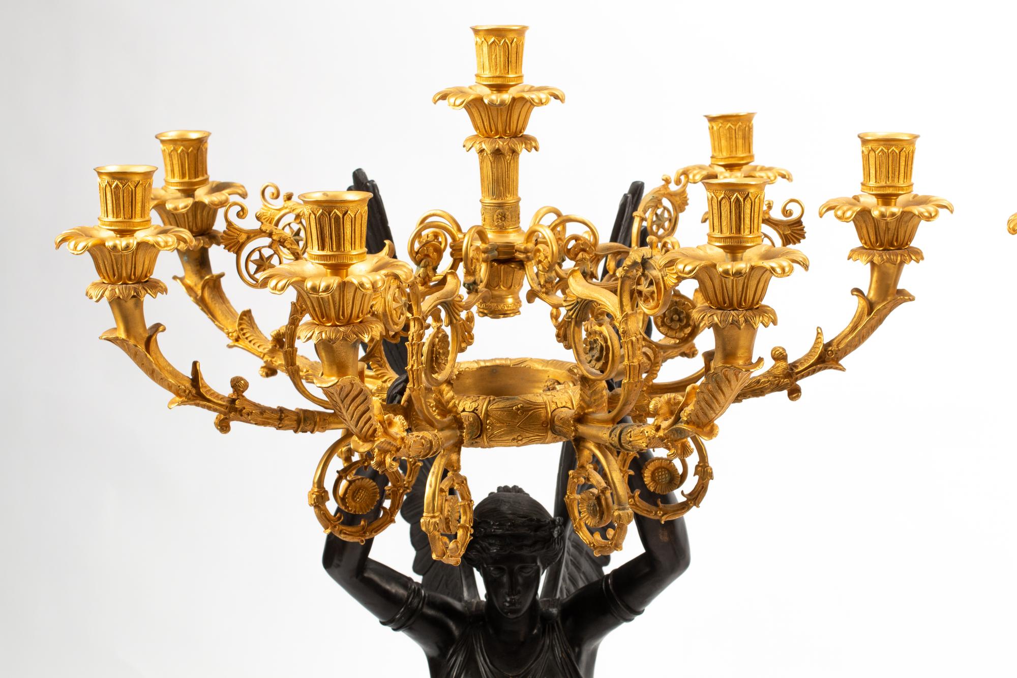 A Pair of Monumental Empire Style Gilt and Patinated Metal Seven-Light Figural Candelabra