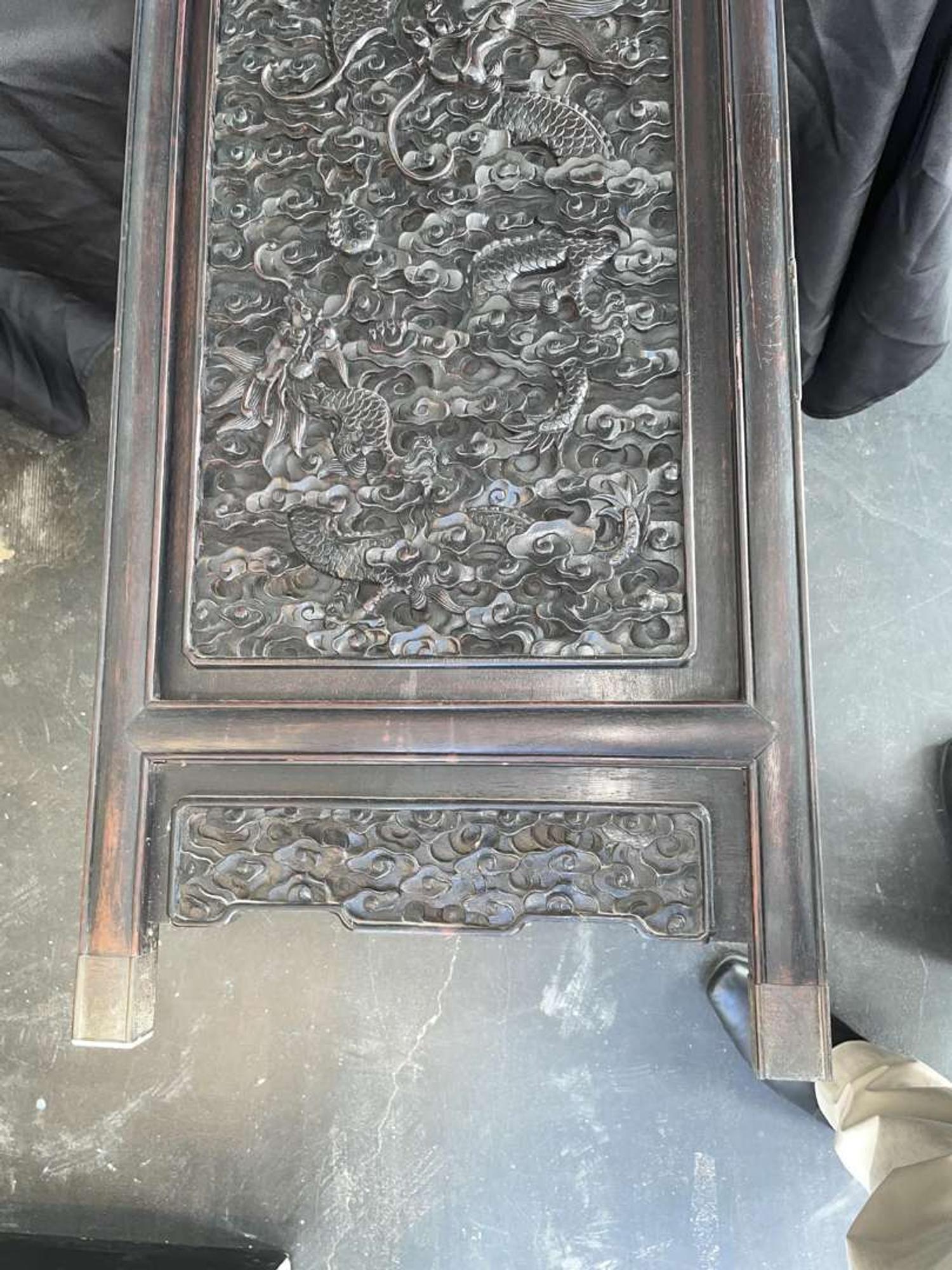 A Chinese carved hardwood six-panel “Dragons” screen 硬木浮雕龙纹六开屏风