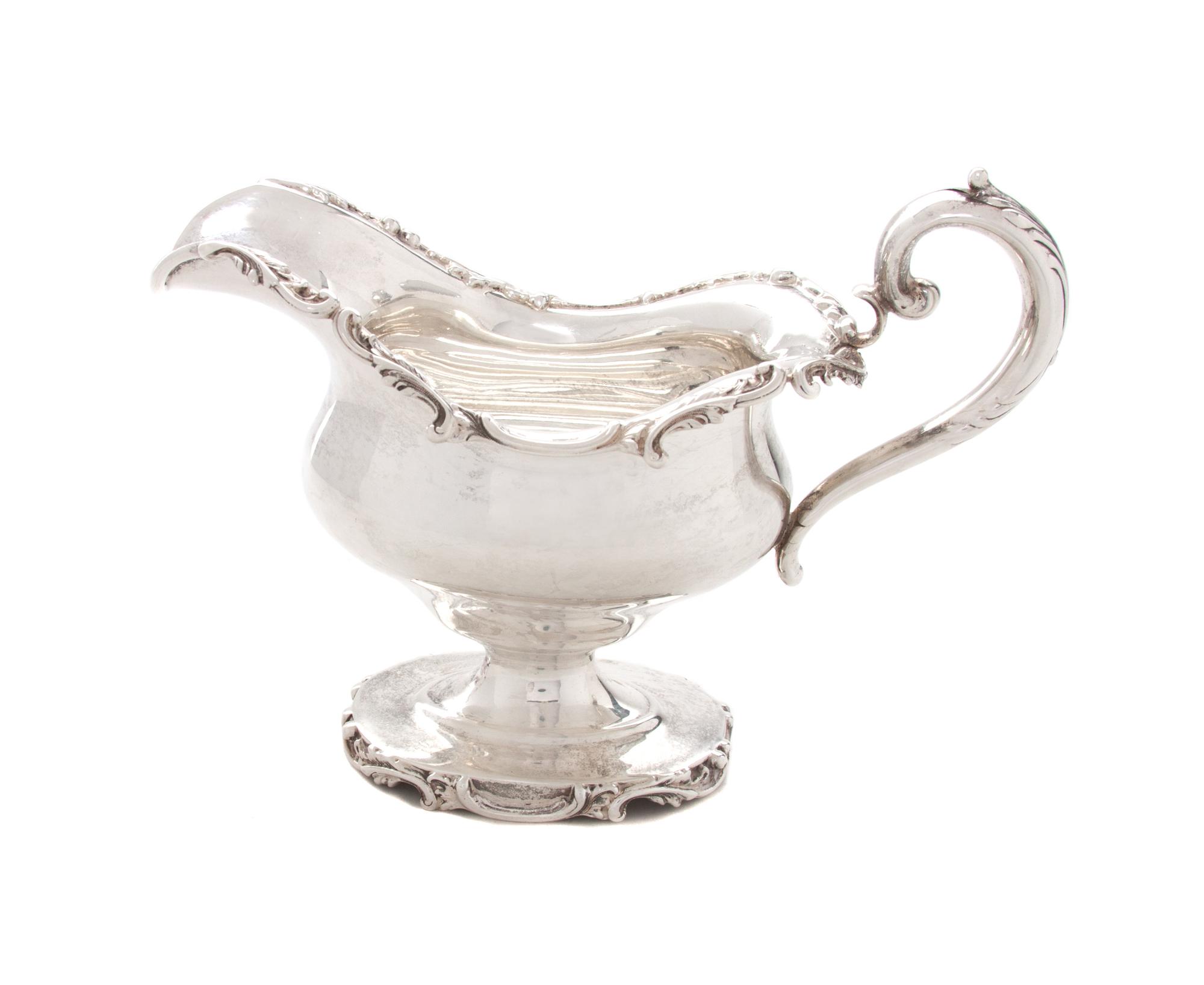 An American Silver Creamer, Black Starr & Frost, New York, NY, Early 20th Century, having scrolling foliate rim and handle, raised on p