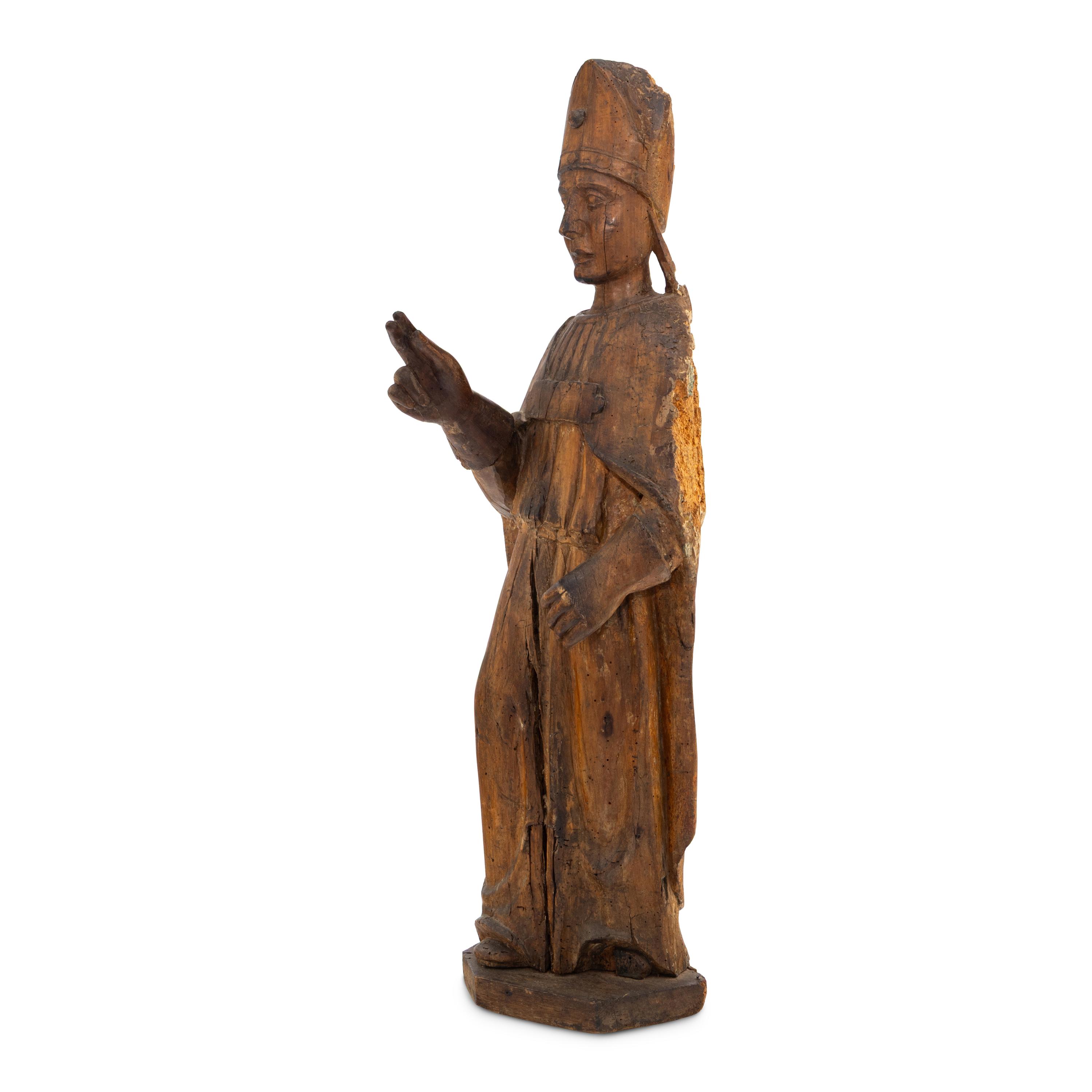 A Carved Walnut Figure of a Bishop