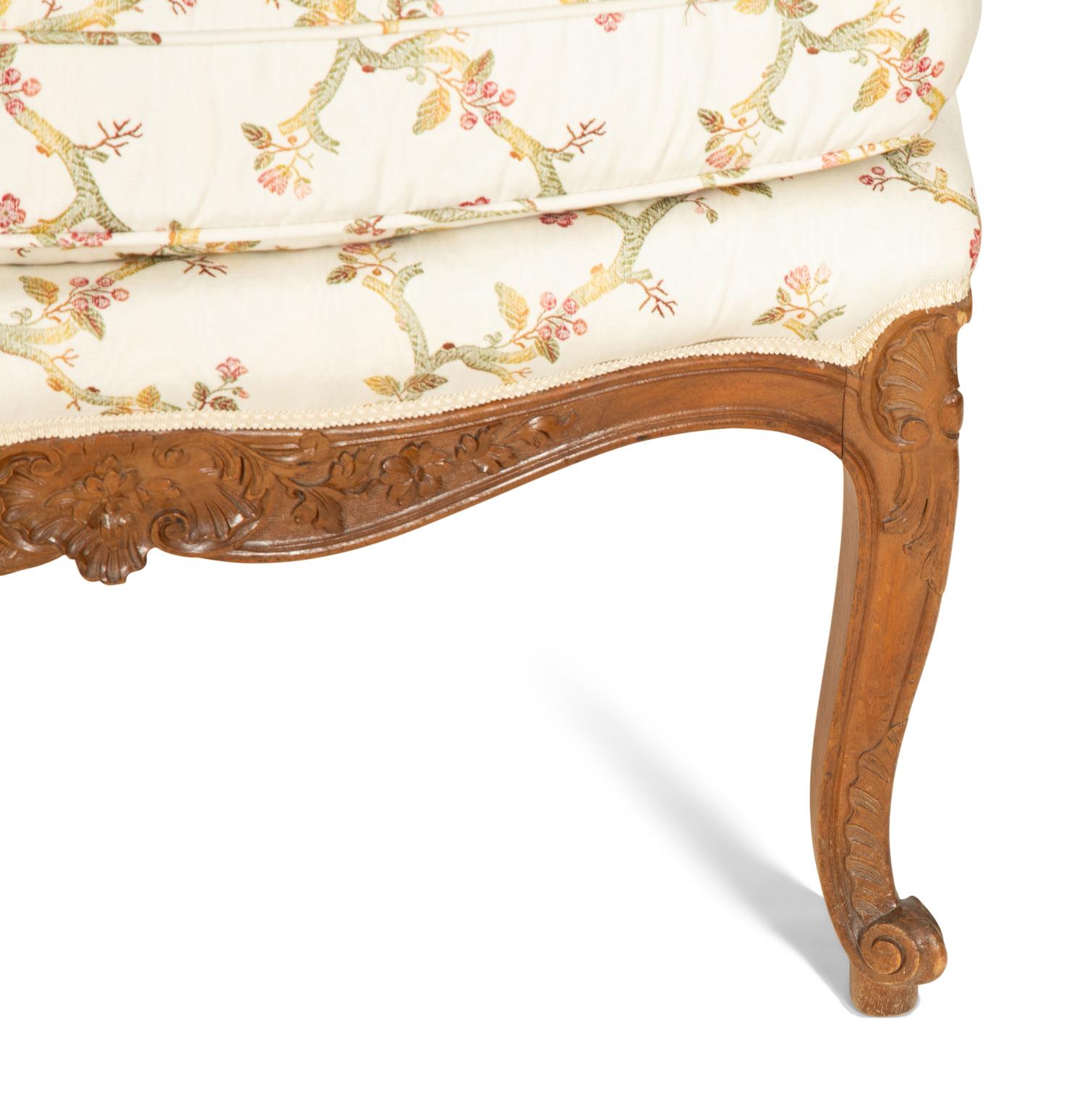 A Pair of Louis XV Style Carved Mahogany Fauteuils