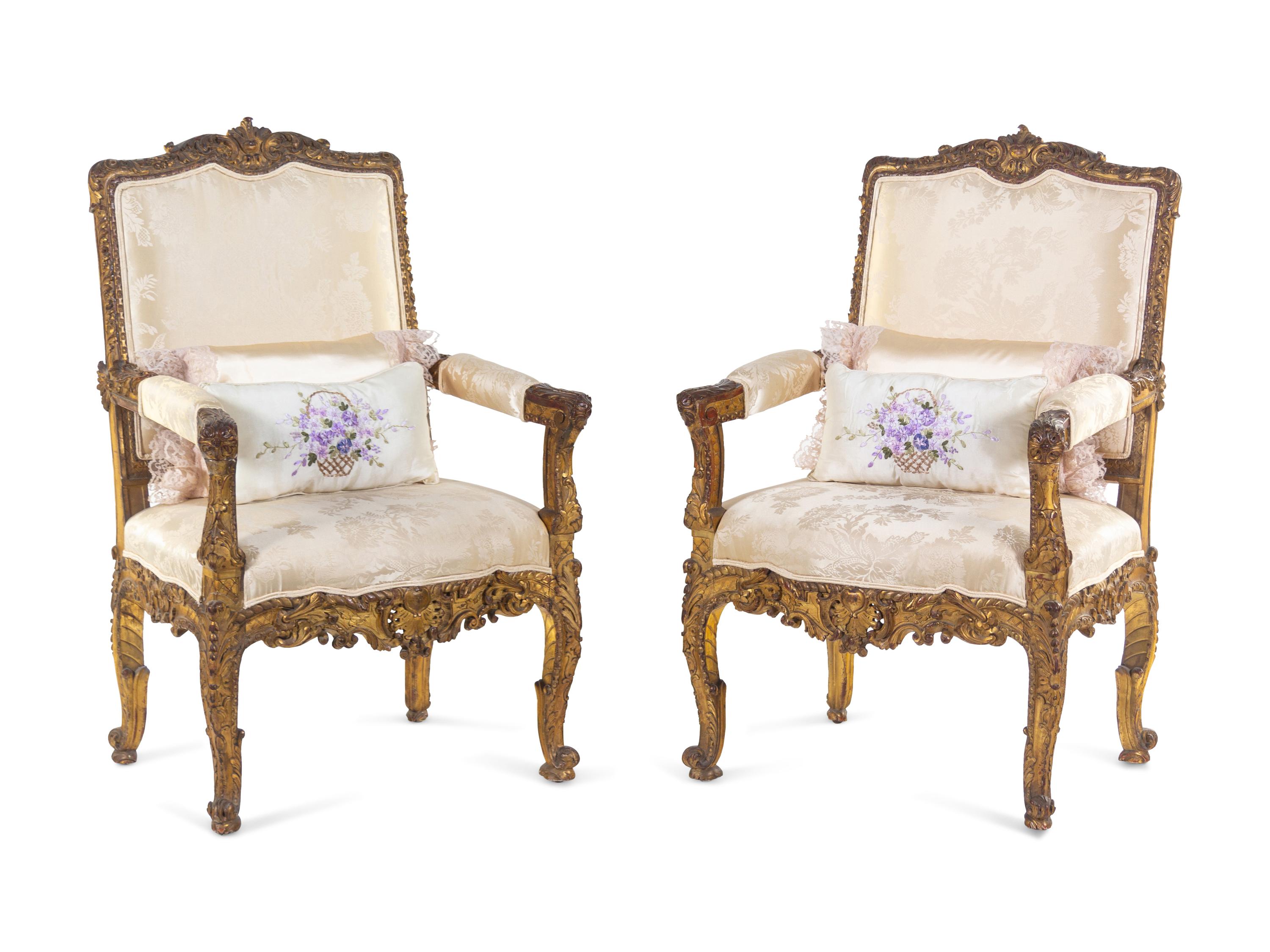 A Pair of Régence Style Carved Giltwood Fauteuils