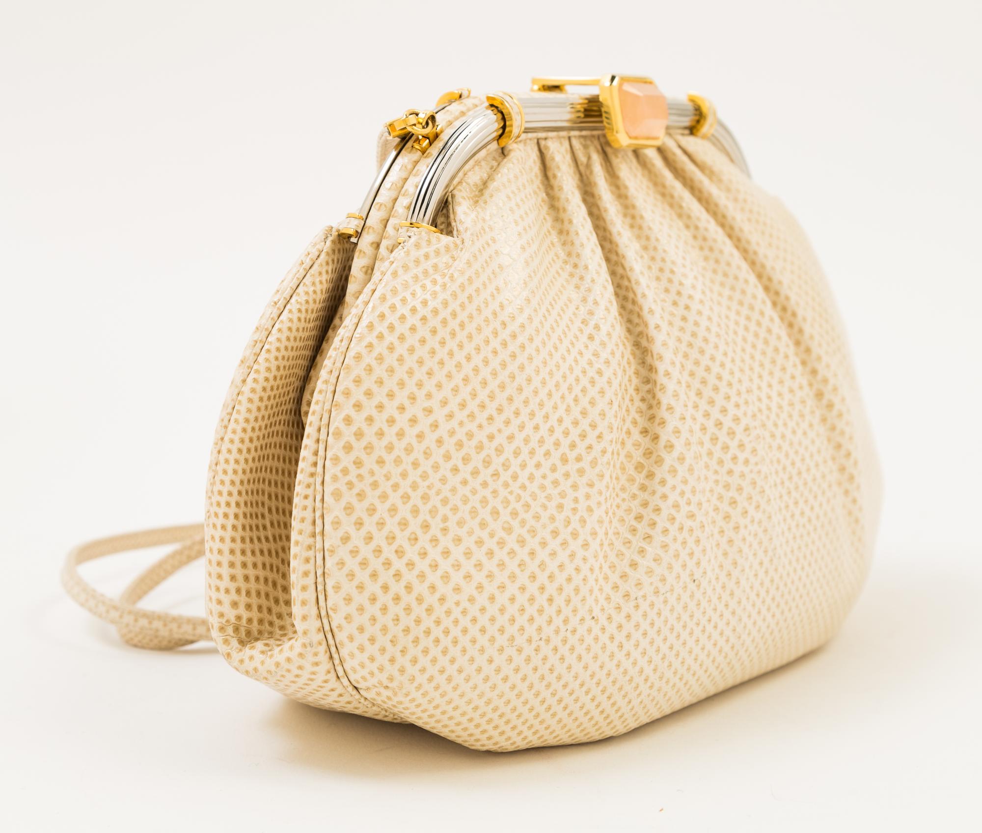 A Judith Leiber Ivory Snakeskin Clutch, 9.5" x 6" x 1.5".