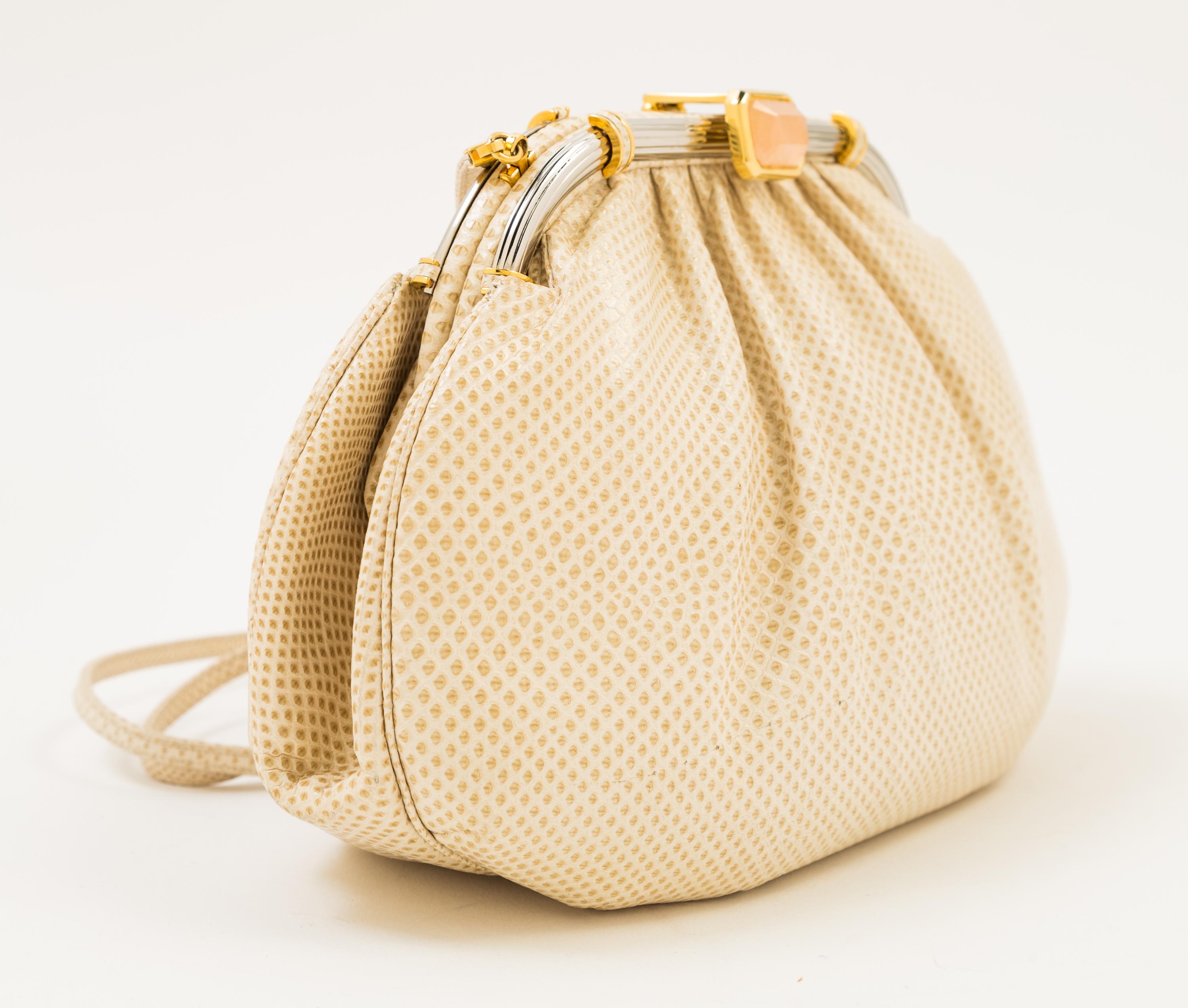A Judith Leiber Ivory Snakeskin Clutch, 9.5" x 6" x 1.5".