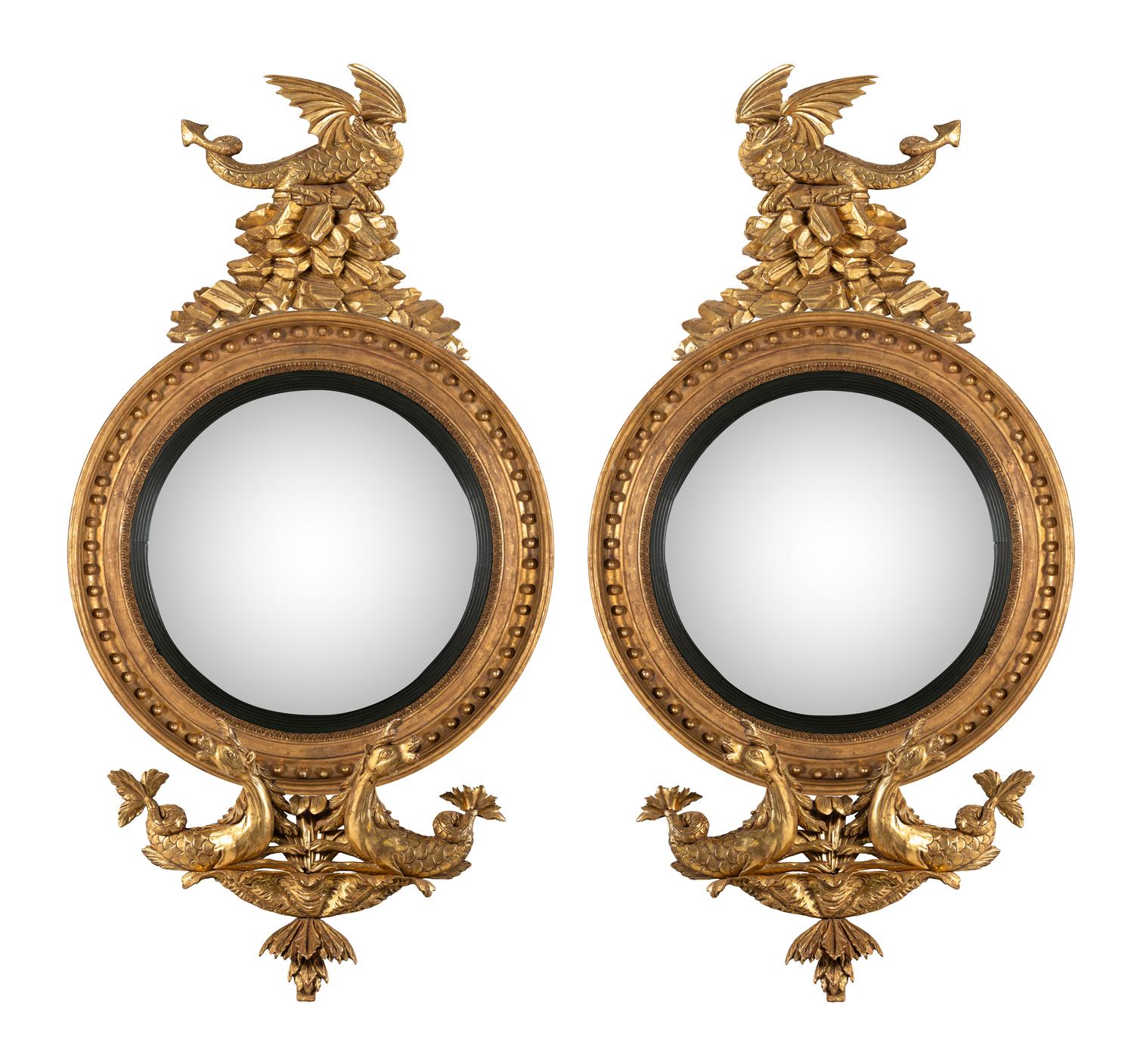 A Pair of Regency Carved Giltwood Convex Wall Mirrors
