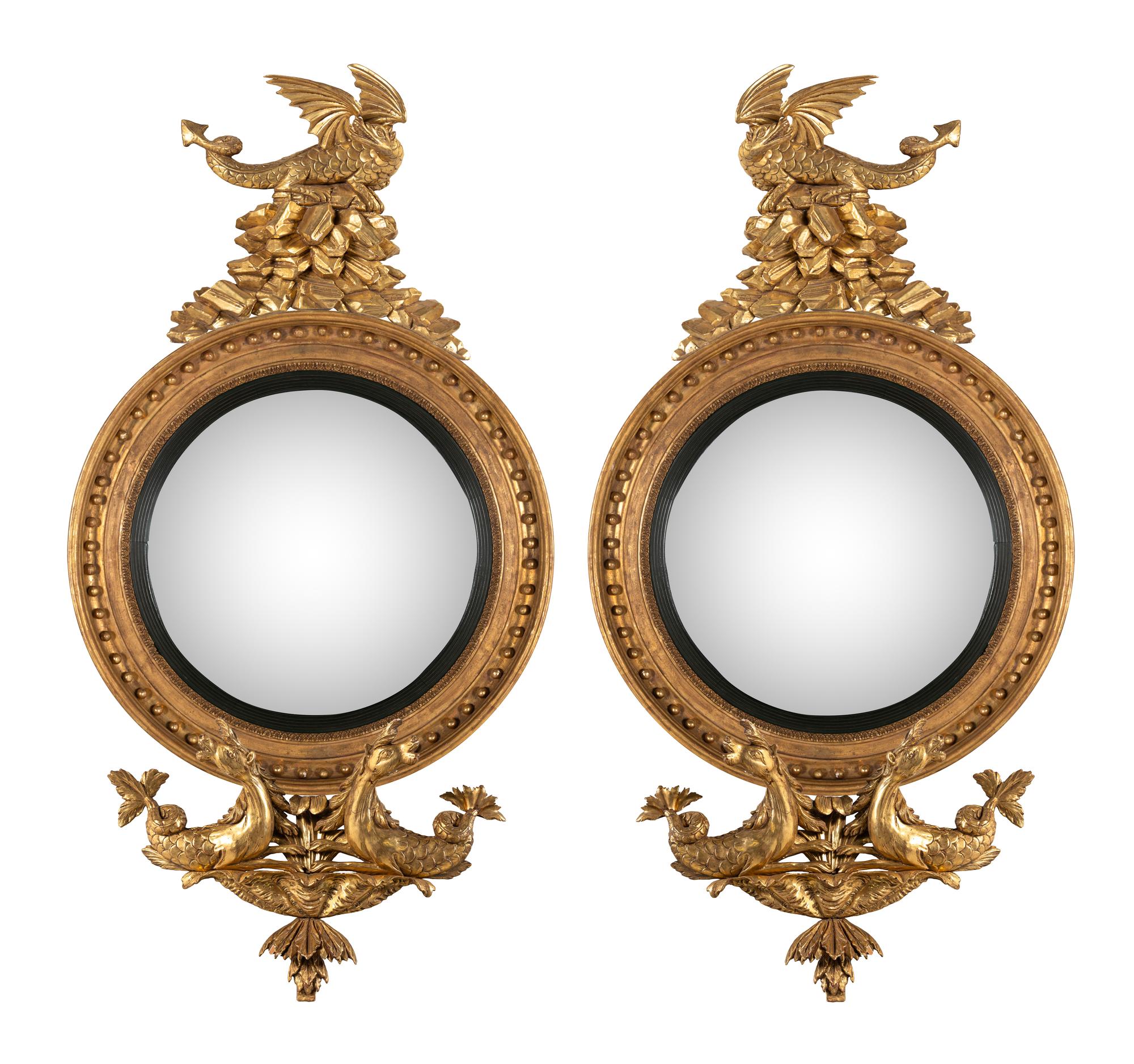 A Pair of Regency Carved Giltwood Convex Wall Mirrors