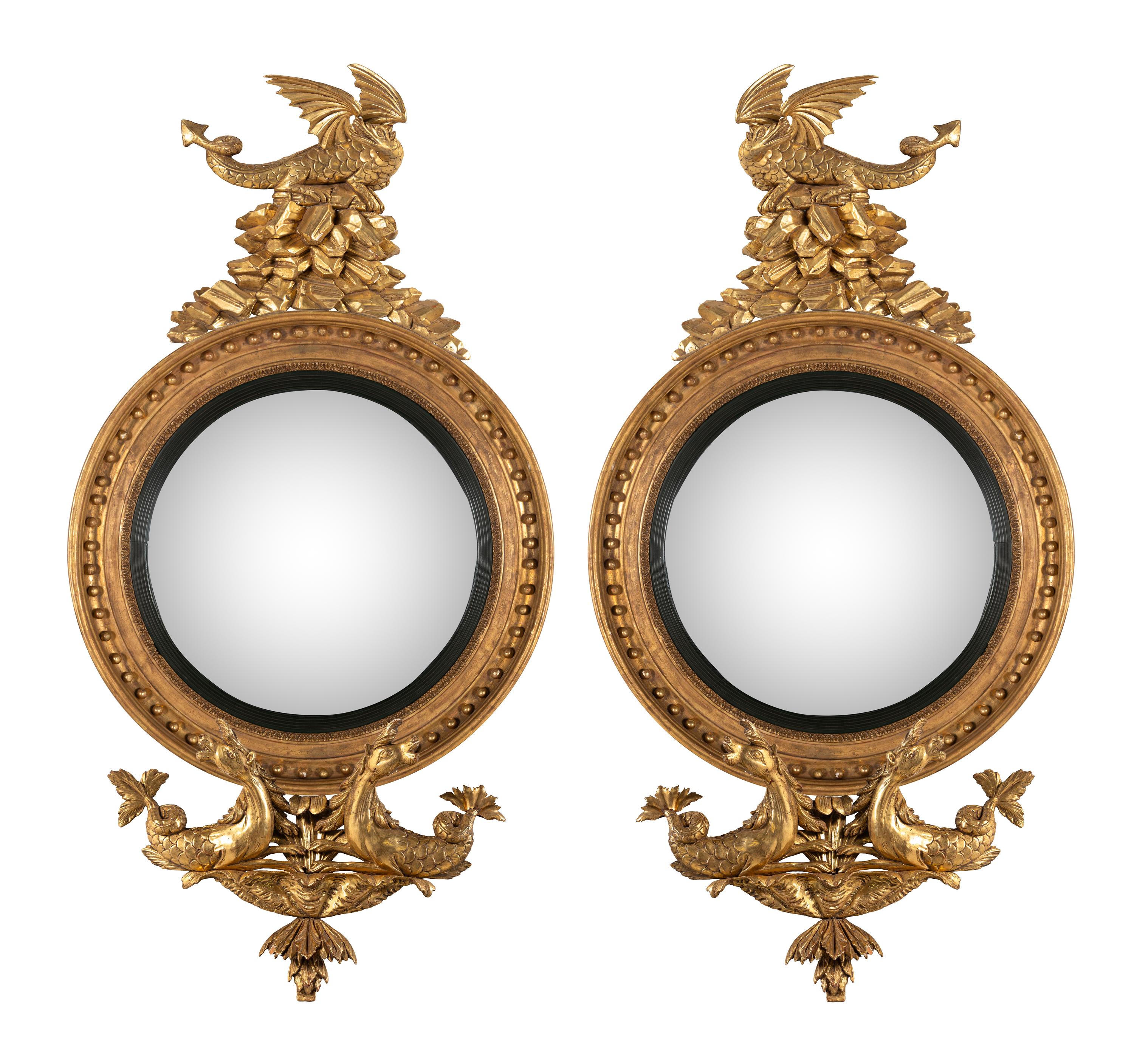 A Pair of Regency Carved Giltwood Convex Wall Mirrors