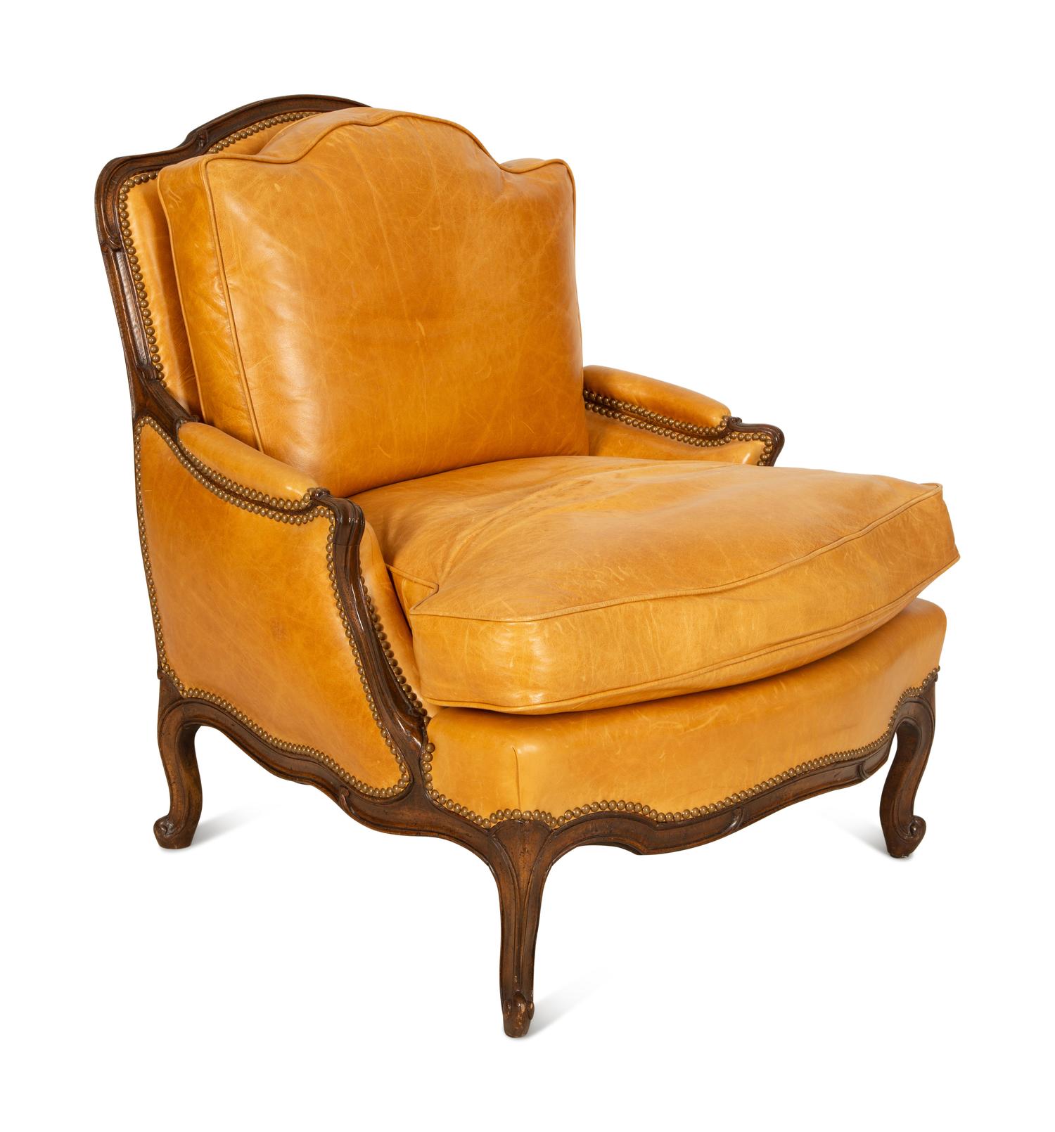 A Louis XVI Style Carved Mahogany Leather Upholstered Bergeré — 20th Century