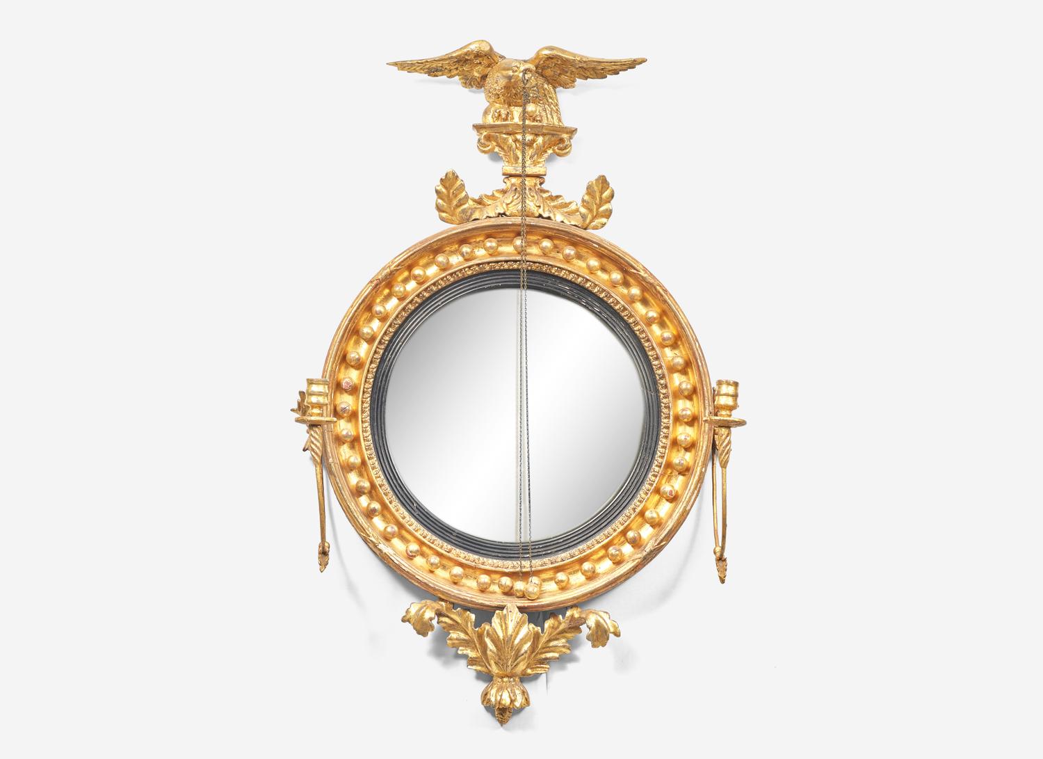 A Classical Giltwood and Parcel Ebonized Convex Two-Light Girandole Mirror