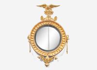 A Classical Giltwood and Parcel Ebonized Convex Two-Light Girandole Mirror