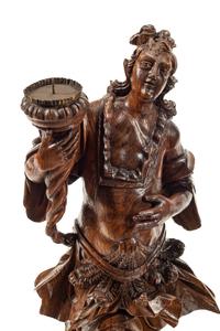 A Pair of Continental Carved Wood Figural Prickets