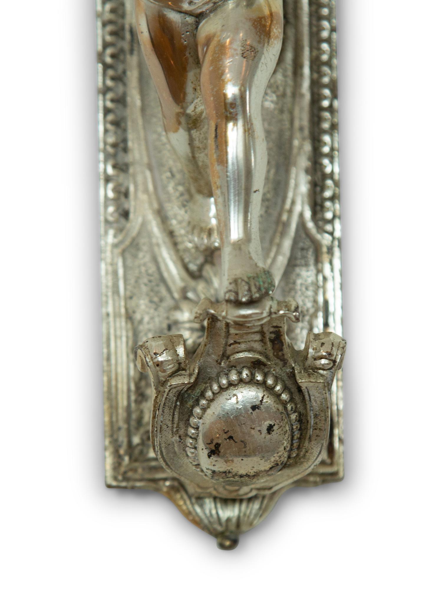 A Pair of Continental Silvered Metal Figural Wall Lights