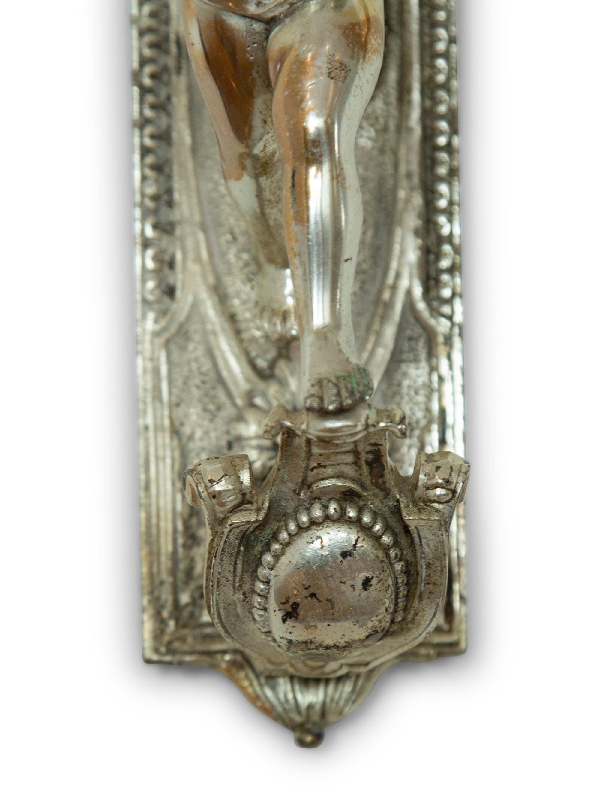A Pair of Continental Silvered Metal Figural Wall Lights
