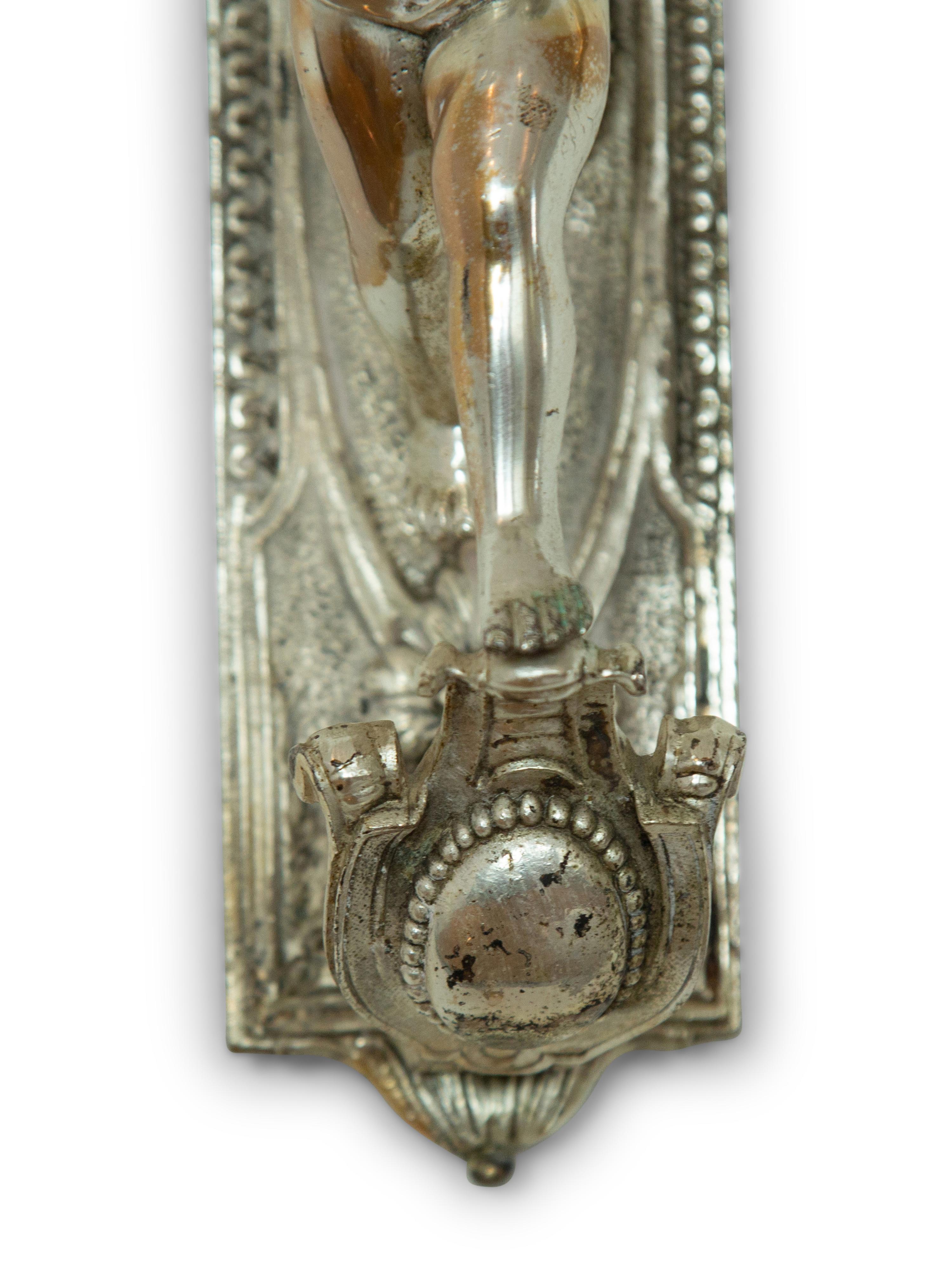 A Pair of Continental Silvered Metal Figural Wall Lights
