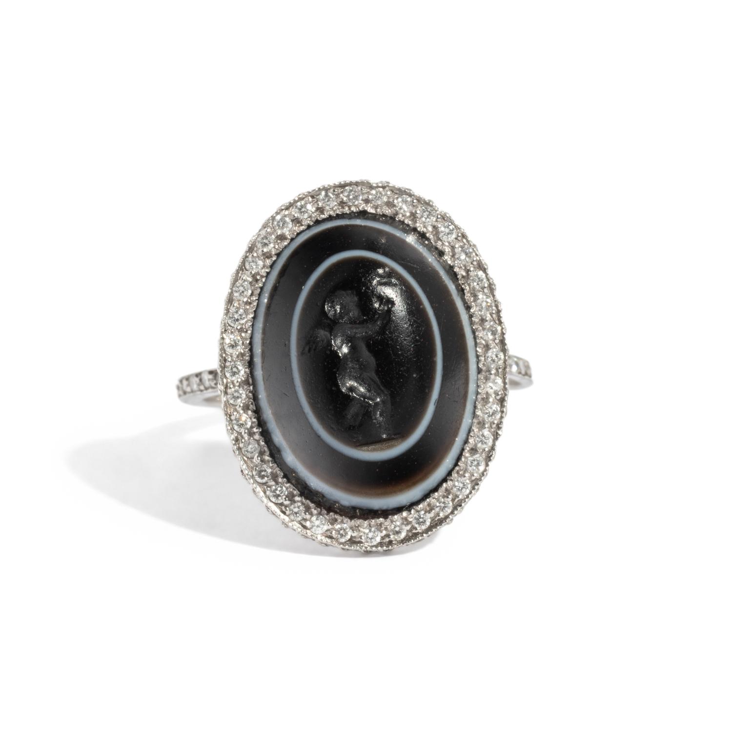 A Roman Banded Agate Ring Stone with the Infant Eros Holding a Butterfly — Set in a silver ring