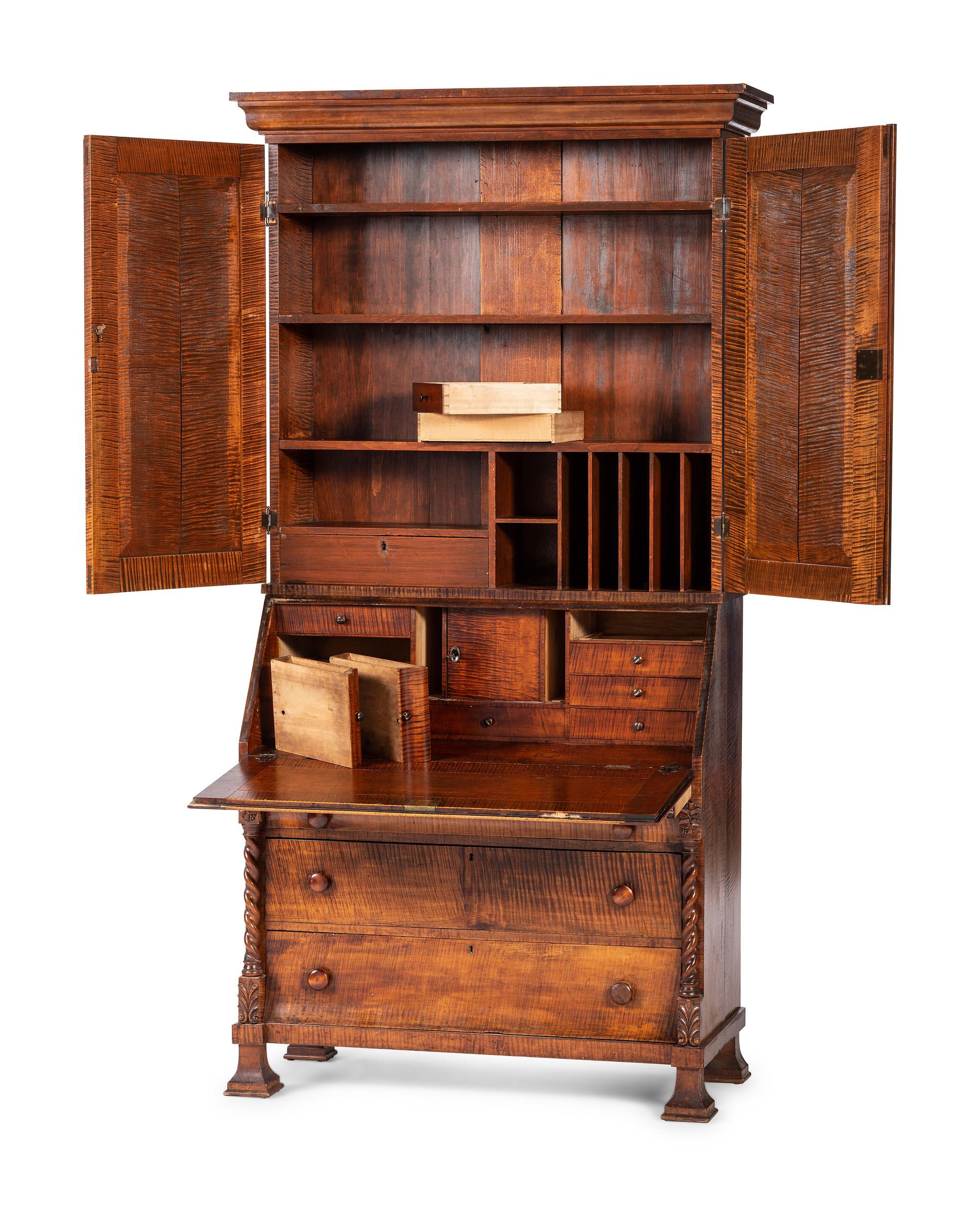 A Classical Style Carved and Highly Figured Tiger Maple Slant Front Desk