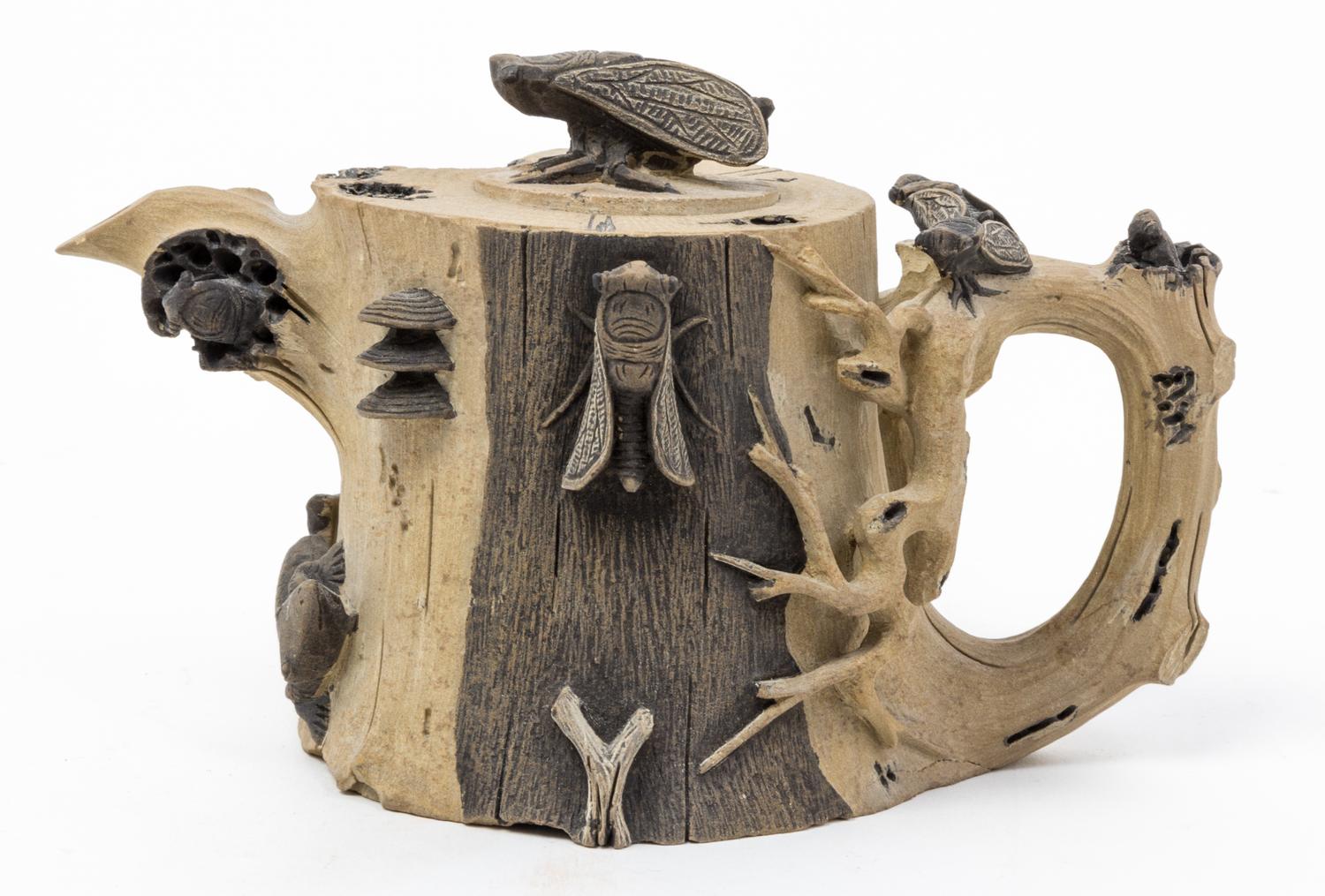 A Chinese Pottery Tea Pot Width over the handle 6 3/4 inches.