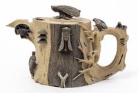 A Chinese Pottery Tea Pot Width over the handle 6 3/4 inches.