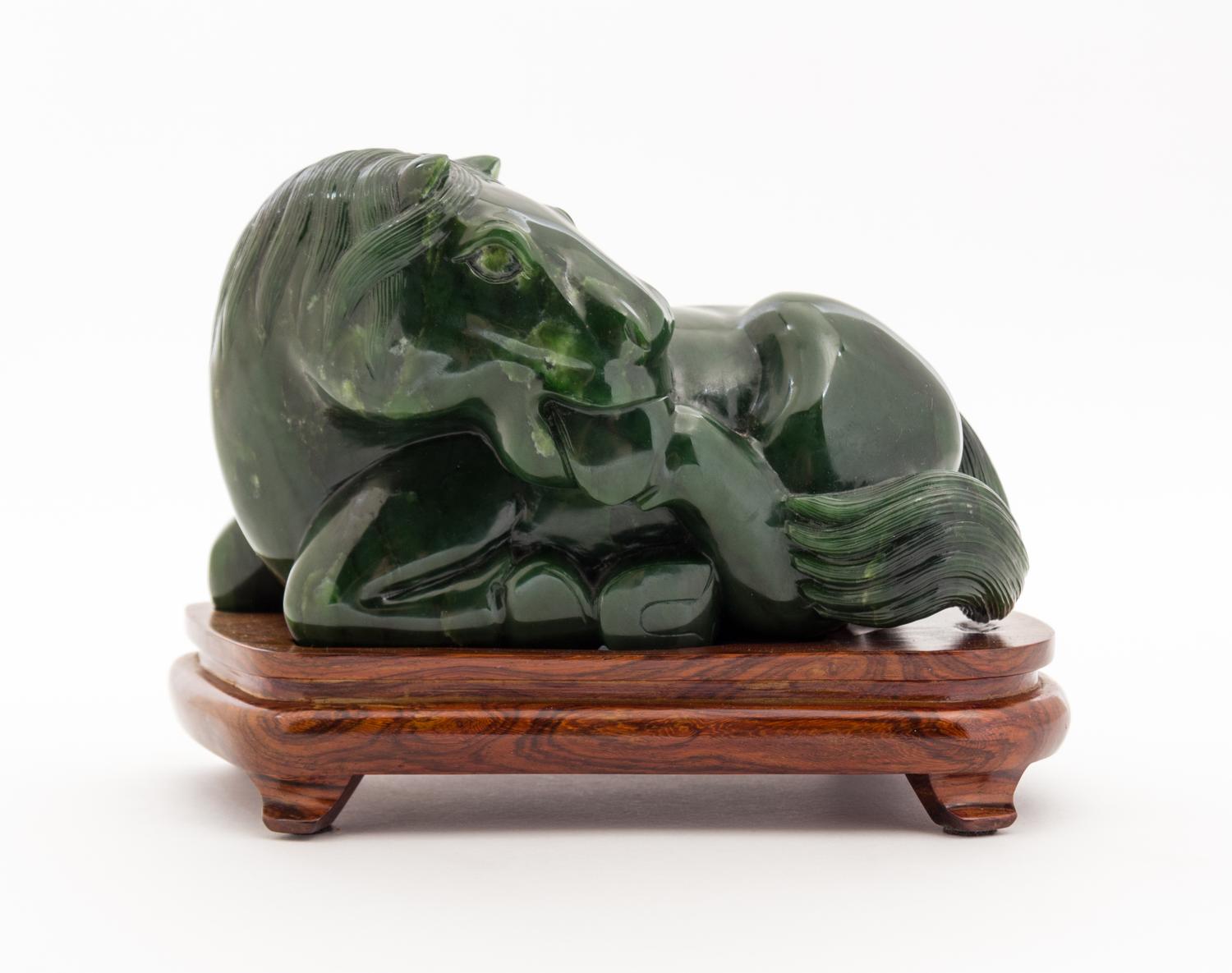 A Carved Jade Figure of a Horse Width 7 inches.