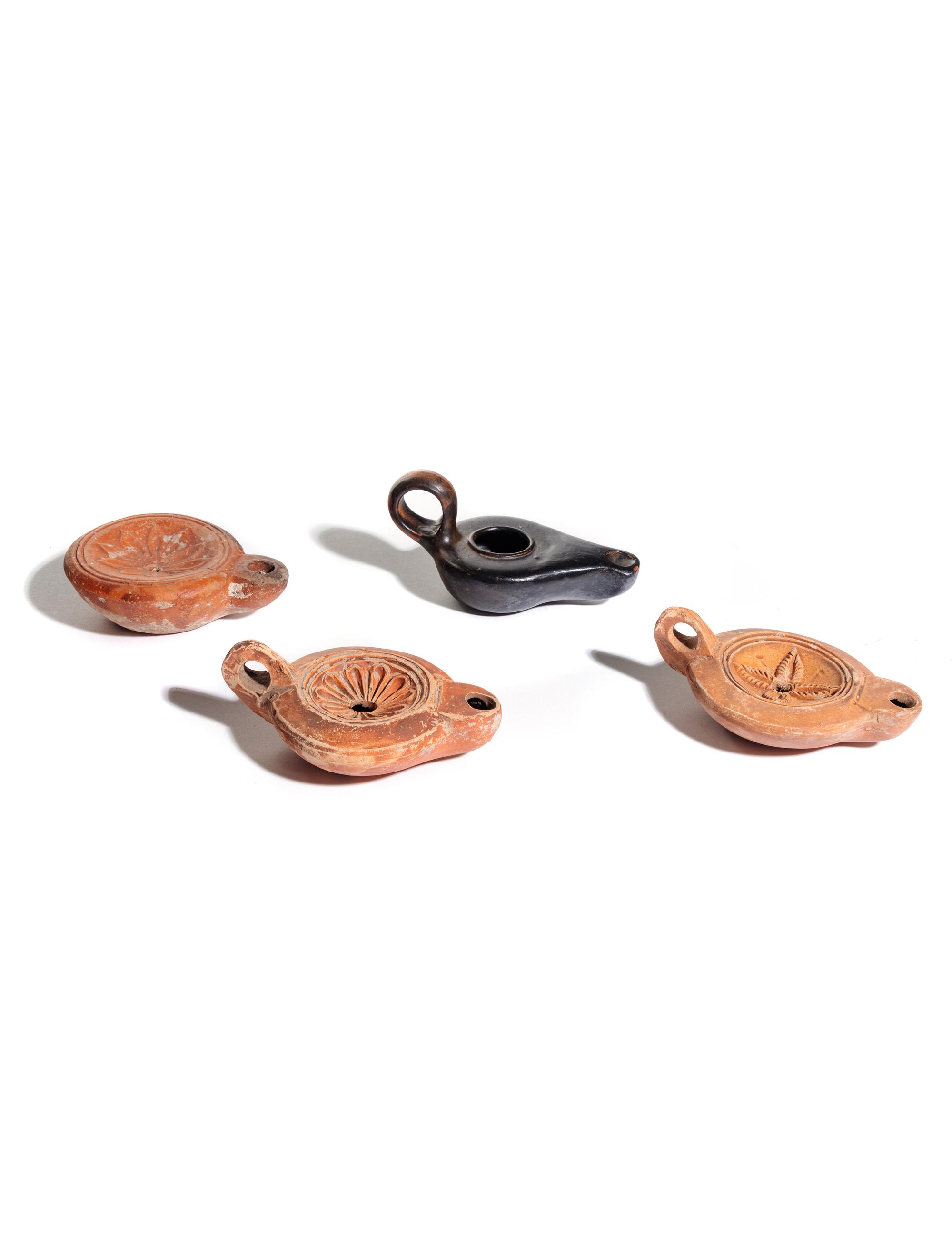 Four Roman Molded Terra Cotta Oil Lamps