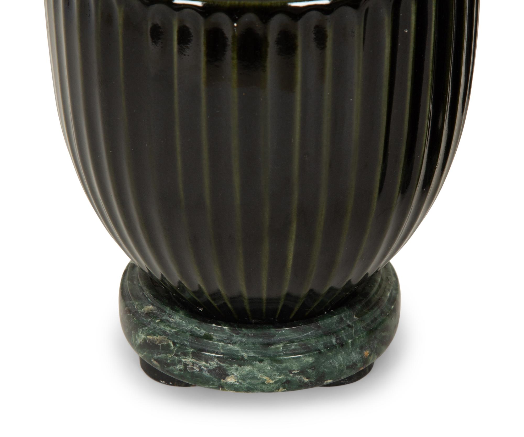 A Pair of Black Porcelain Urns on Green Marbelized Bases