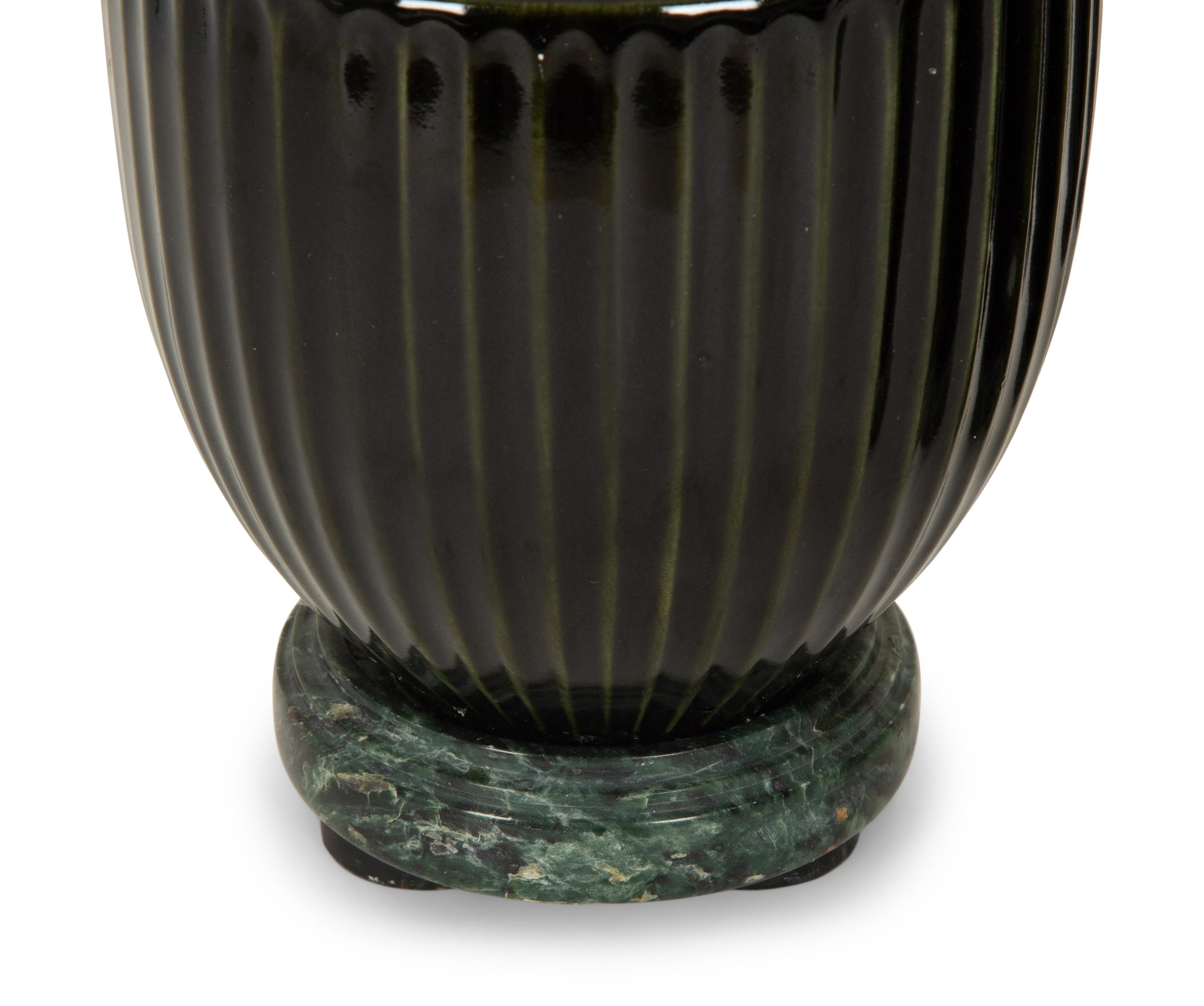 A Pair of Black Porcelain Urns on Green Marbelized Bases