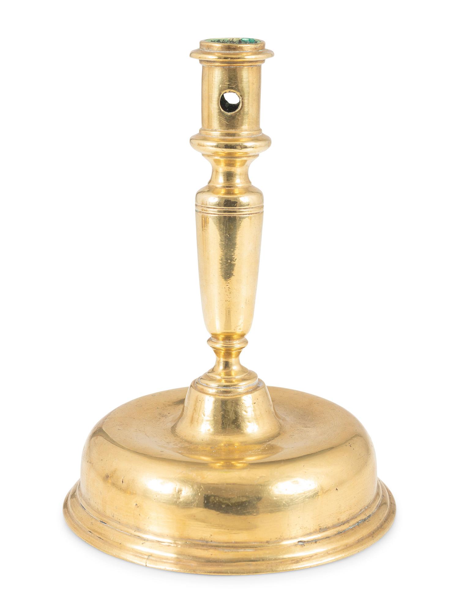 A Continental Brass Bell-Bottom Candlestick
