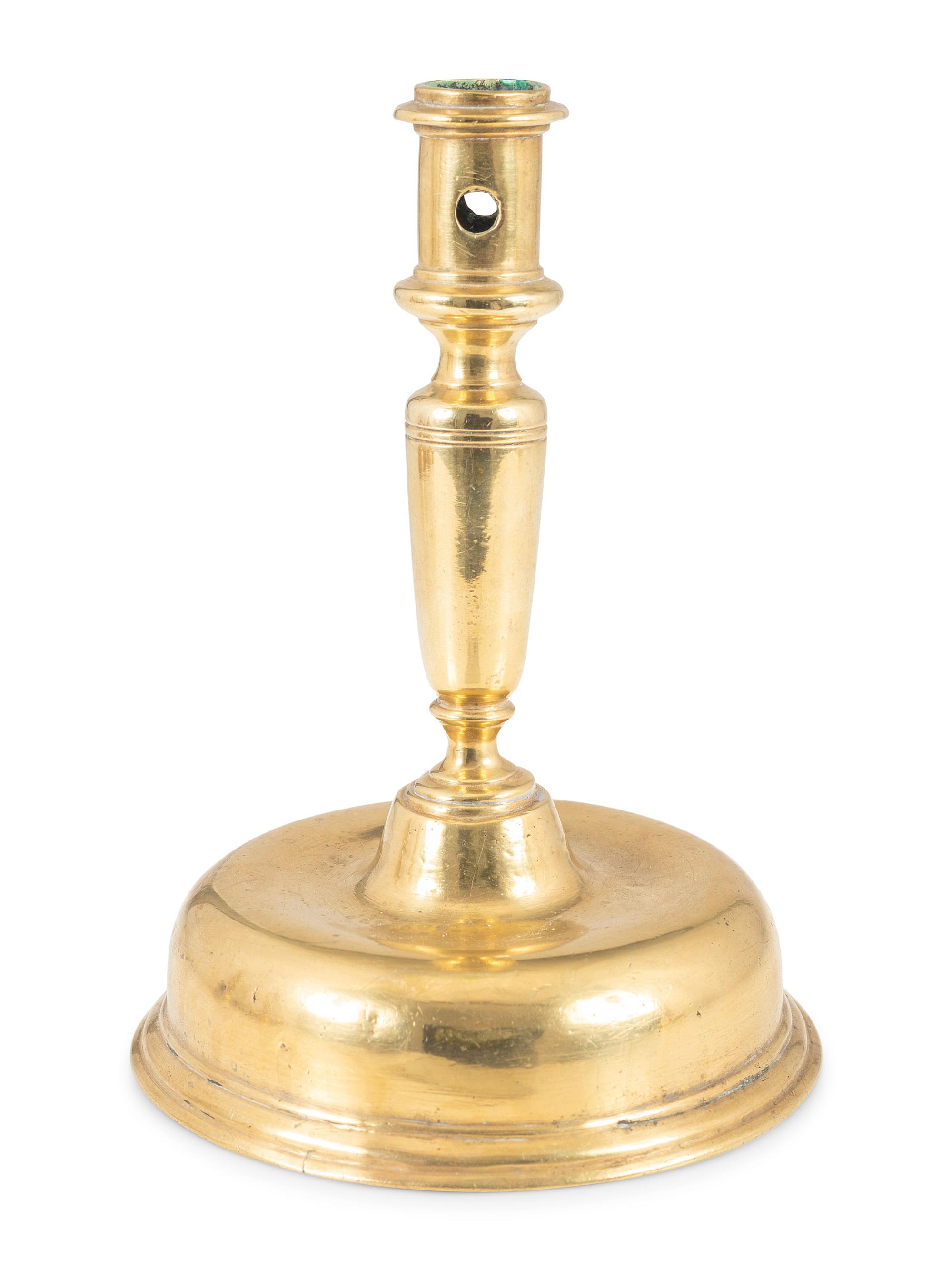 A Continental Brass Bell-Bottom Candlestick