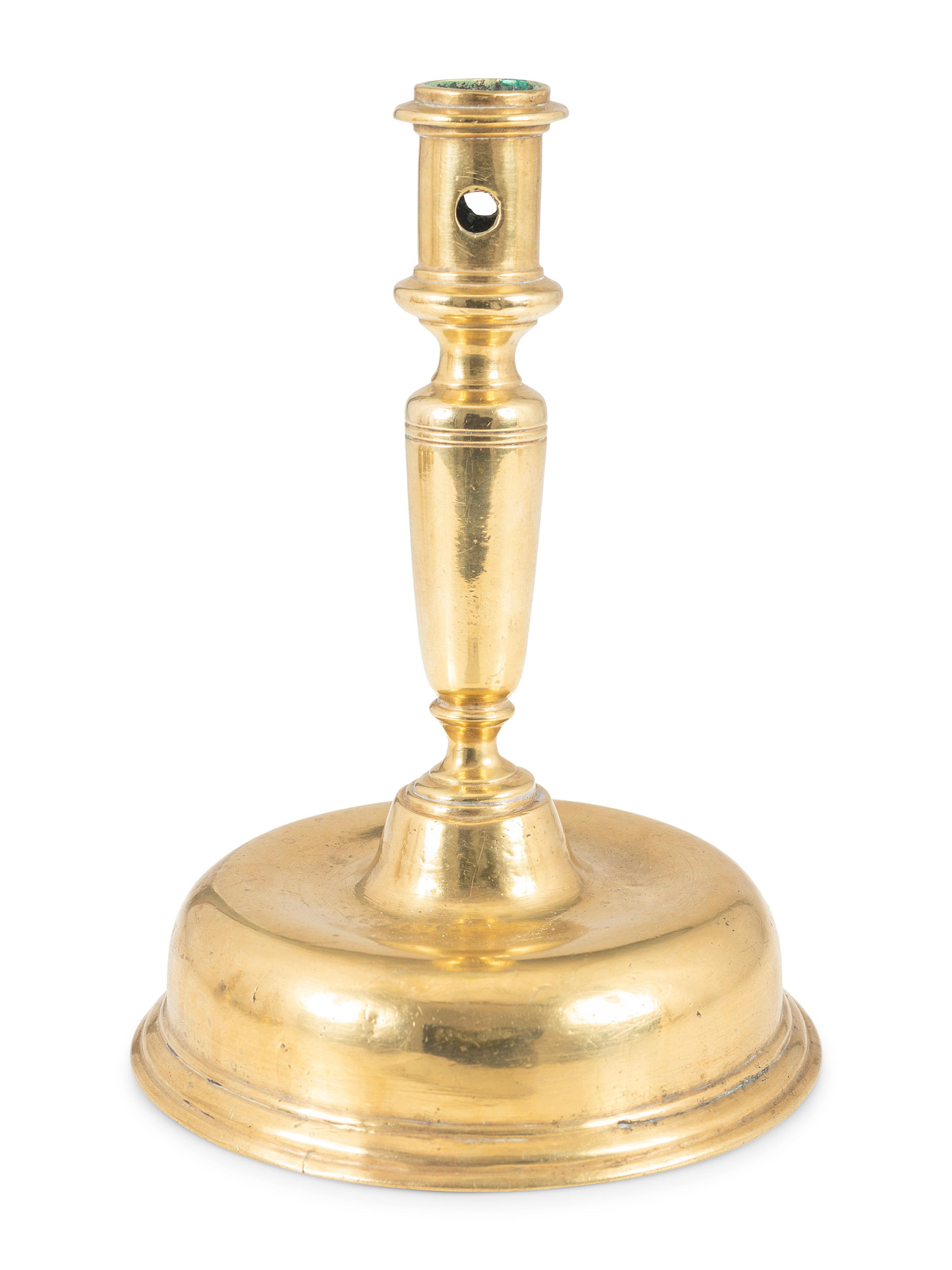 A Continental Brass Bell-Bottom Candlestick