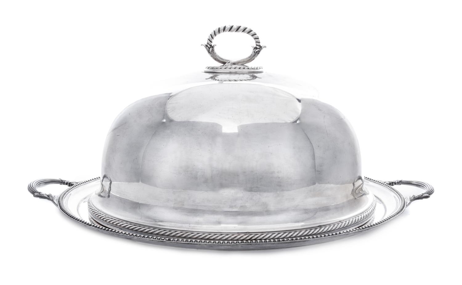 An English Silver-Plate Cloche and Tray, Elkington Silver Co., Birmingham, each of oval form, the handled tray centered with a crest fe