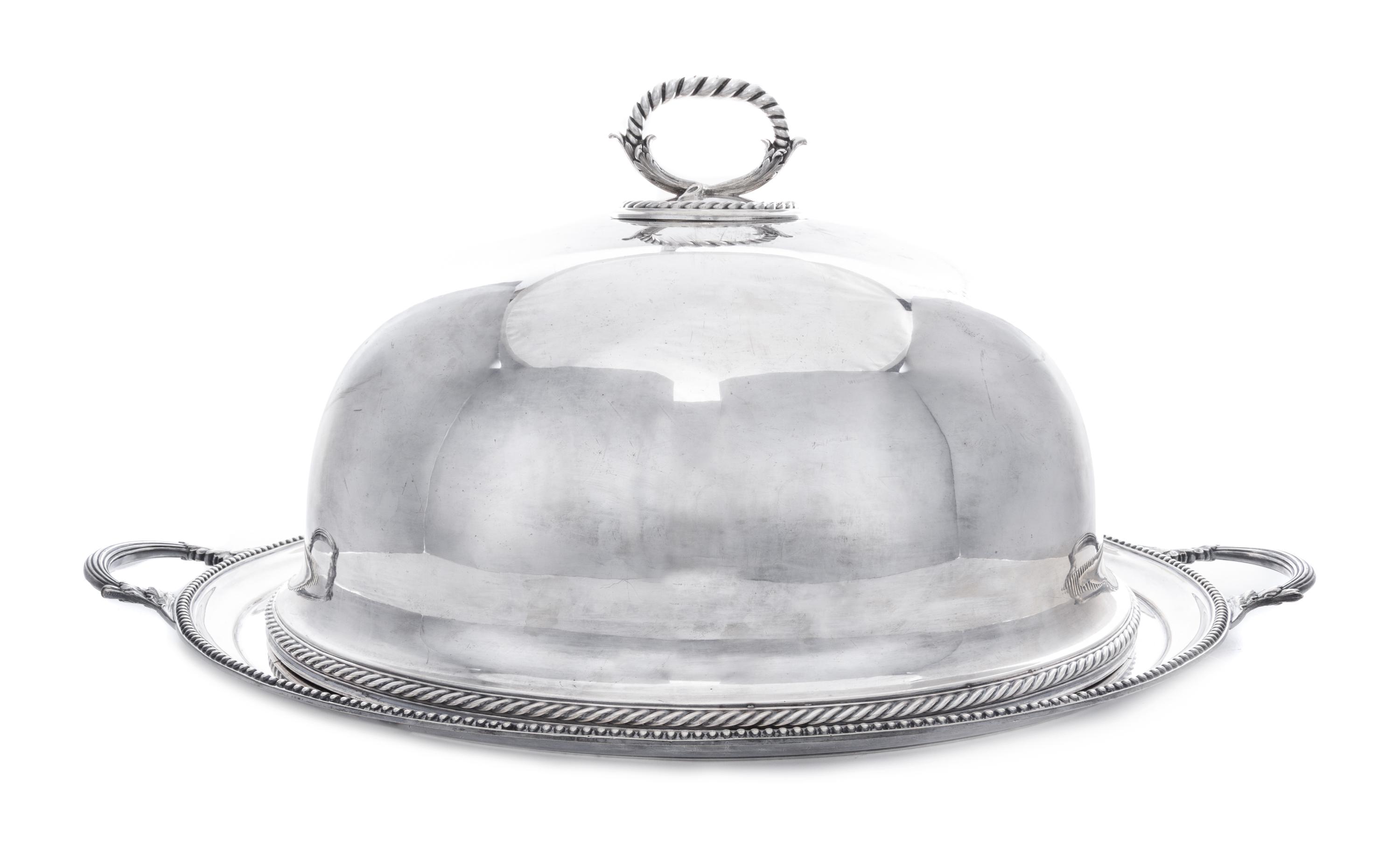 An English Silver-Plate Cloche and Tray, Elkington Silver Co., Birmingham, each of oval form, the handled tray centered with a crest fe